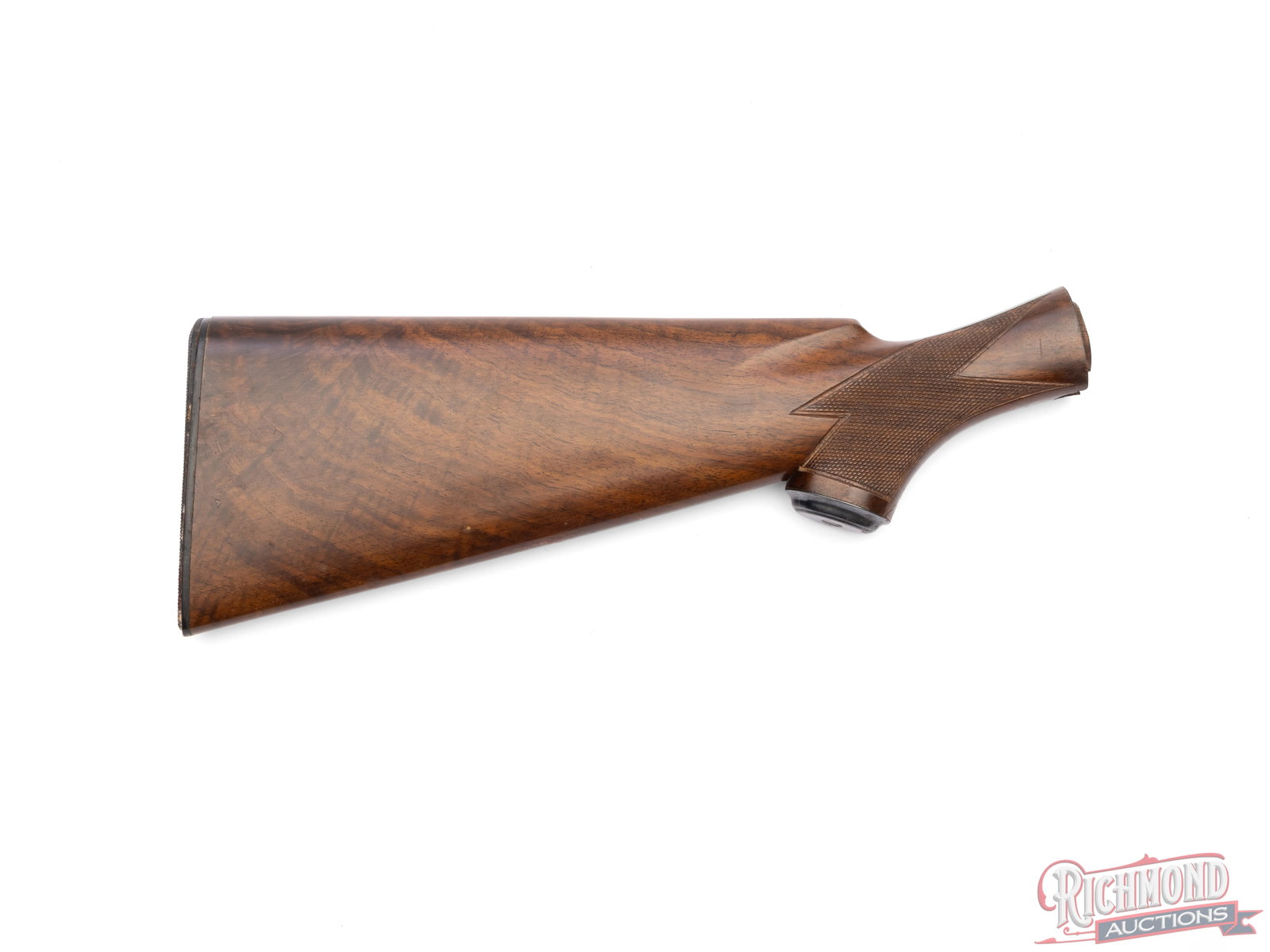 Winchester Wooden Stock: This Winchester stock is fitted with a rubber butt pad and checkered grip. It measures 15" long at its longest point. Left side of the stock shows scratches and a crack behind the grip. Condition GOOD