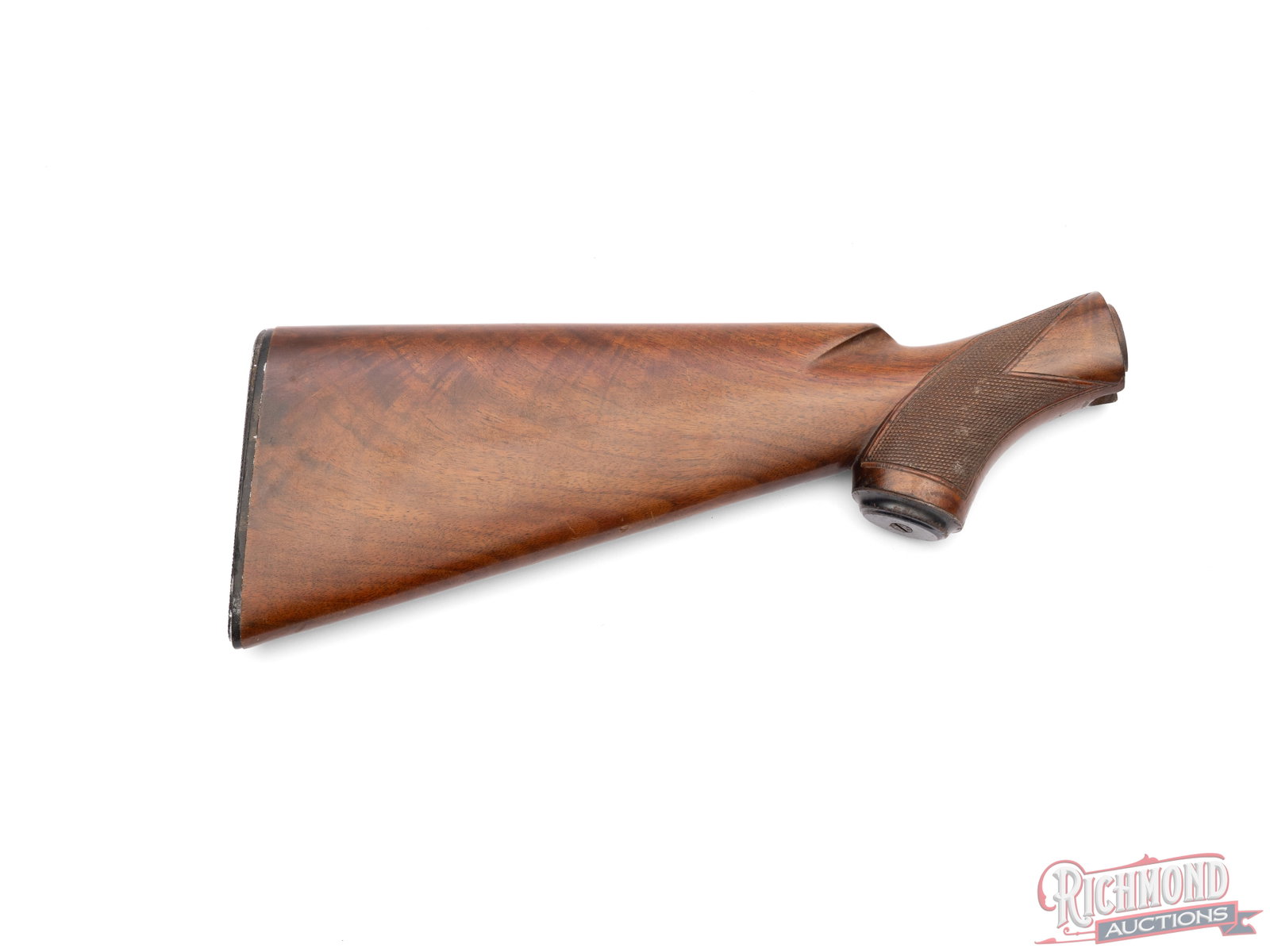 Winchester Wooden Stock: This Winchester stock is fitted with a rubber butt pad and checkered grip. It measures 14 1/4" long at its longest point. Right side of the stock has some scratches. Condition GOOD