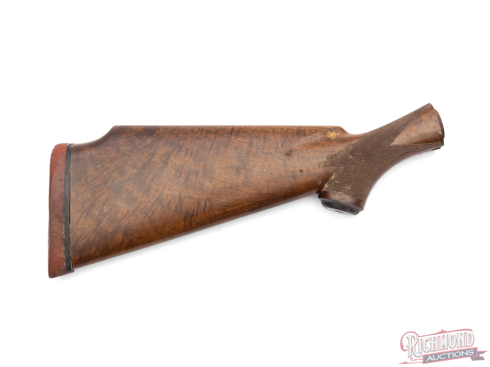 Winchester Wooden Stock With Recoil Pad: This Winchester stock is fitted with a rubber butt pad and checkered grip. It measures 15 1/2" long at its longest point. The left side is cracked at the grip and runs halfway down the stock.