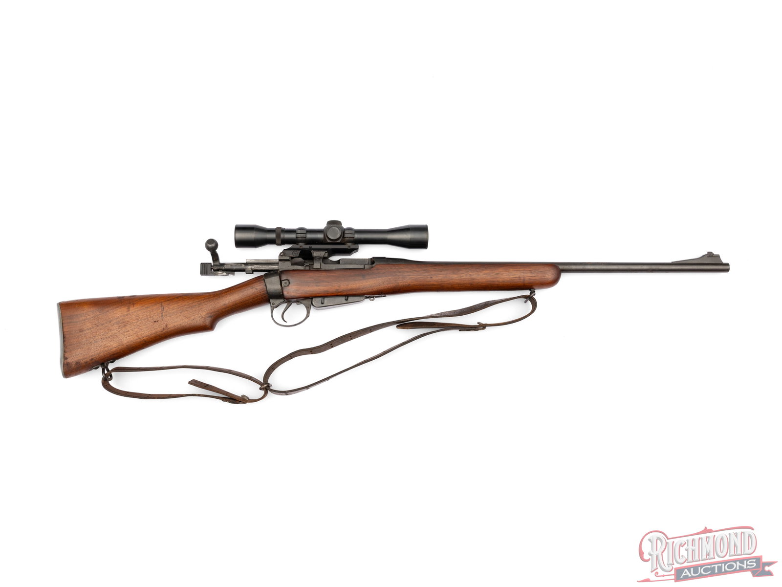 Sporterized Enfield No. 4 Mk 1 Bolt Action Rifle .303 Caliber With Weaver Scope: This No. 4 Mk 1 rifle was built by Fazakerly in England. It features a 22" barrel with blade style front sight. It is fitted with a wooden stock and forend with sling swivels and a partially torn