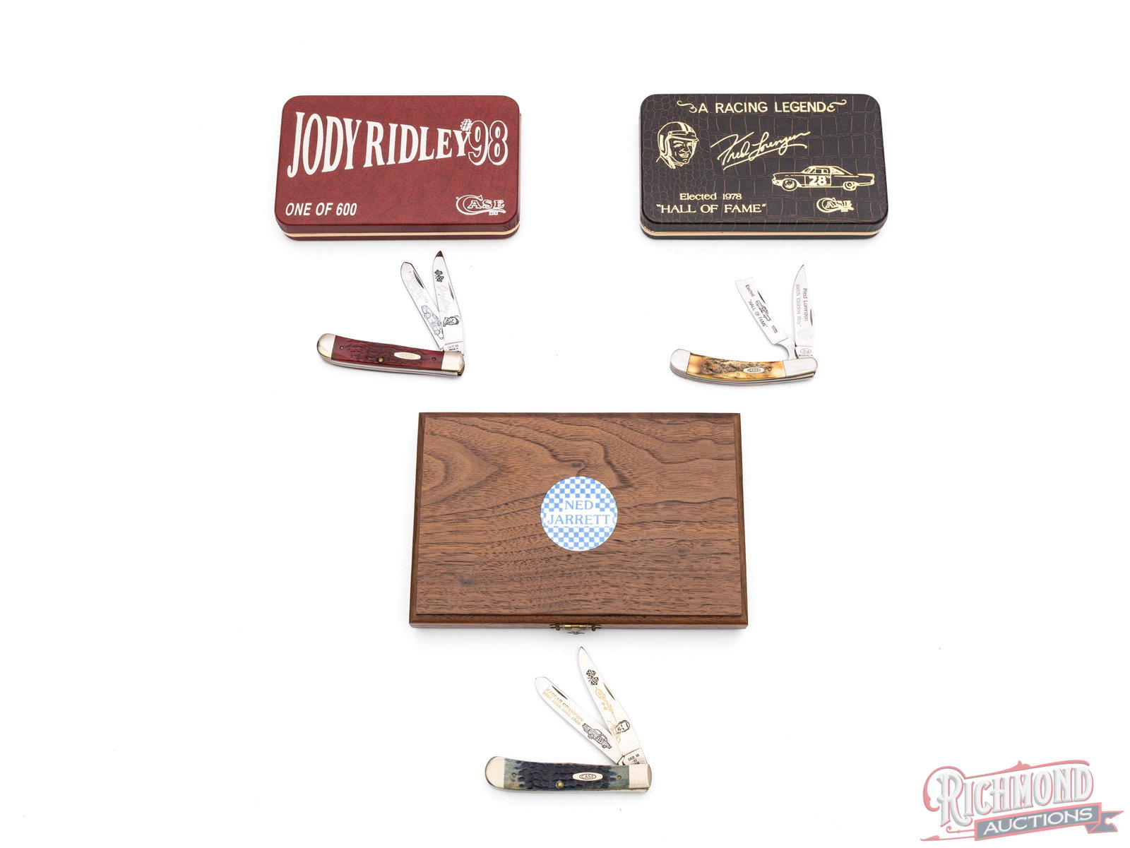Three Case XX Nascar Legends Commemorative Folder Knives in Original Cases: This lot includes three Case XX Racing Legends commemorative folder knives. One model BR6254 SS Jody Ridley Five Time All-Pro Champion with two etched blades and red jigged bone handles. Includes a CO