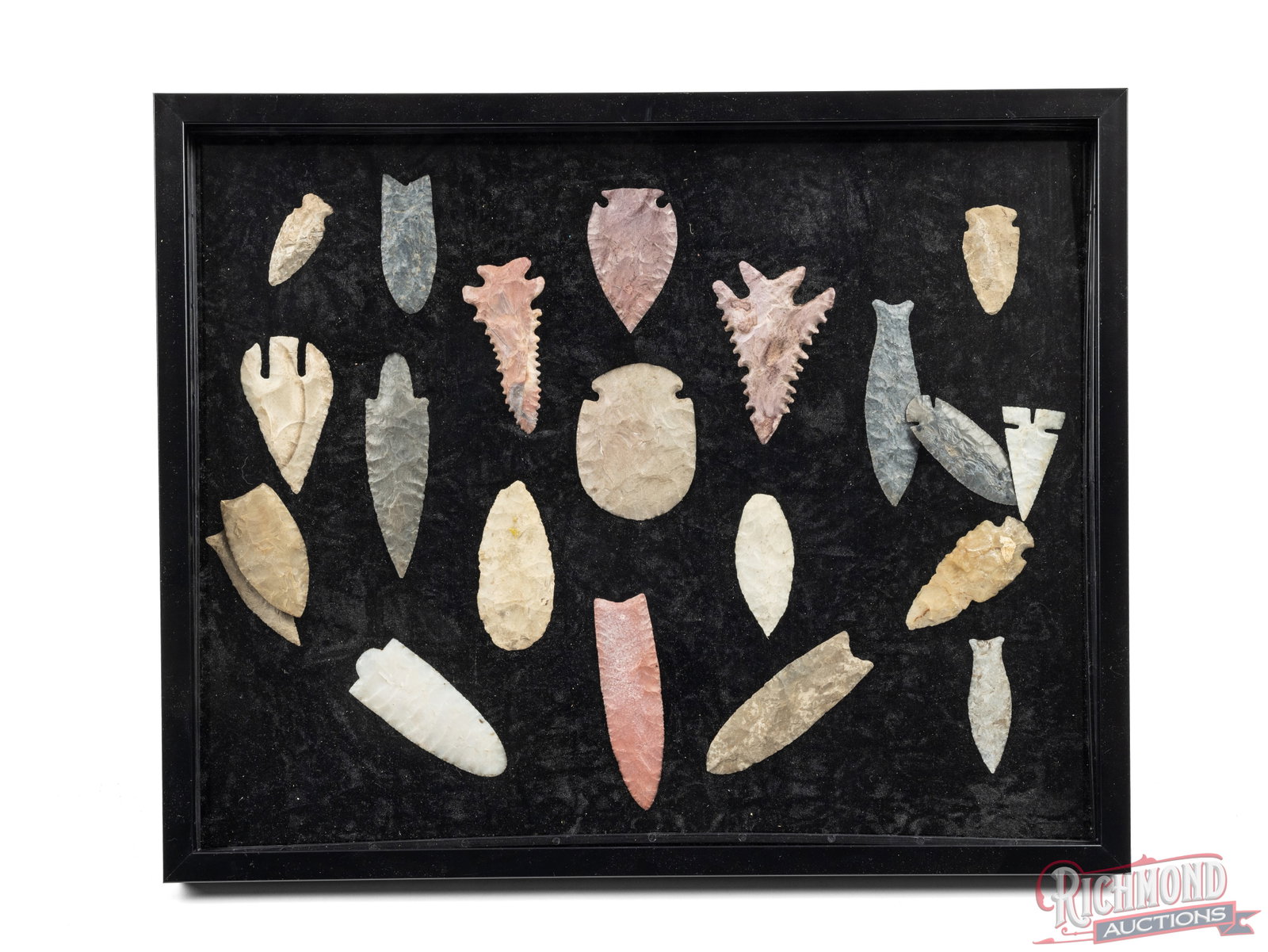 Collector Display of 20 Assorted Native American Arrowheads: This framed display includes 20 various arrowheads that range from 2-5" long. It features arrowheads of various different stone types and with bot rounded and pointed edges. Great collector set with