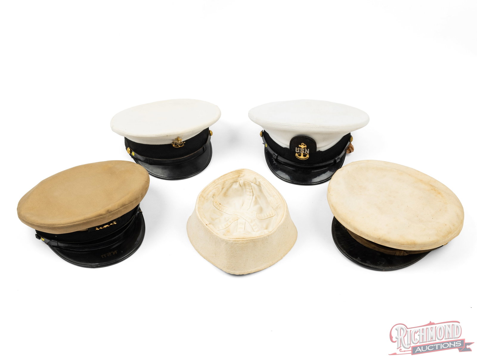 Collection of Five US Navy Hats: This collection includes 5 different pieces of head wear of the US Navy. Included is one tan and three white officer's hat and one sailor's hat. Two of the officers hats were manufactured by Alco