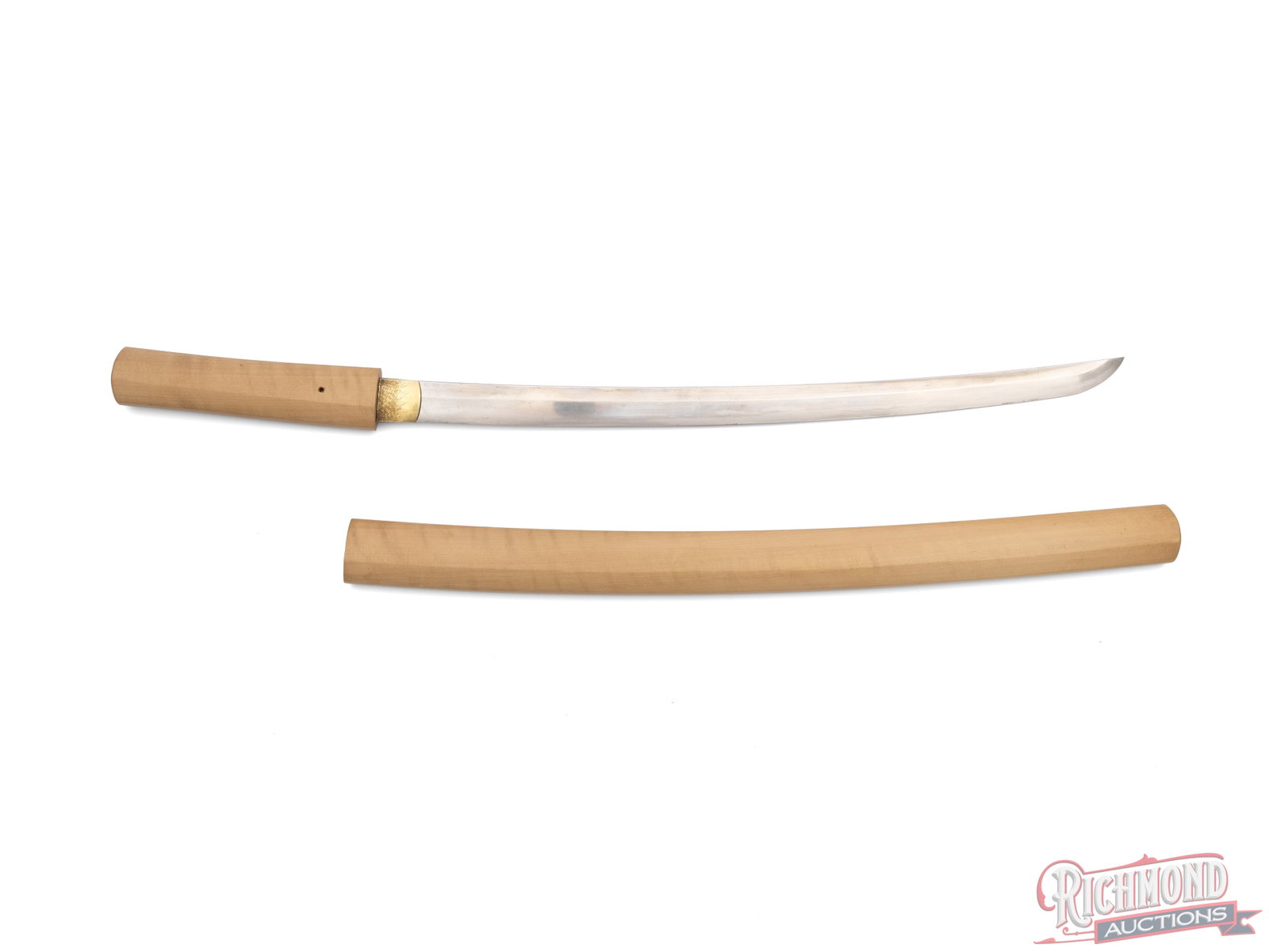 Shin Shinto Japanese Sword: This Japanese sword features an 18" blade and measures 26" overall. The blase has a visible tempered area and an engraved blade collar. The wood of the scabbard and handle are smooth and clean.