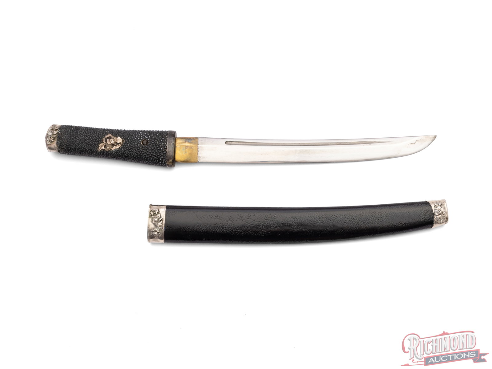 Iorimune Tanto Japanese Blade: This Tanto blade features a 10" blade and measures 16 1/2" overall length. It is fitted into a black scabbard with a floral design on both ends. The handle is black rayskin with a floral design on