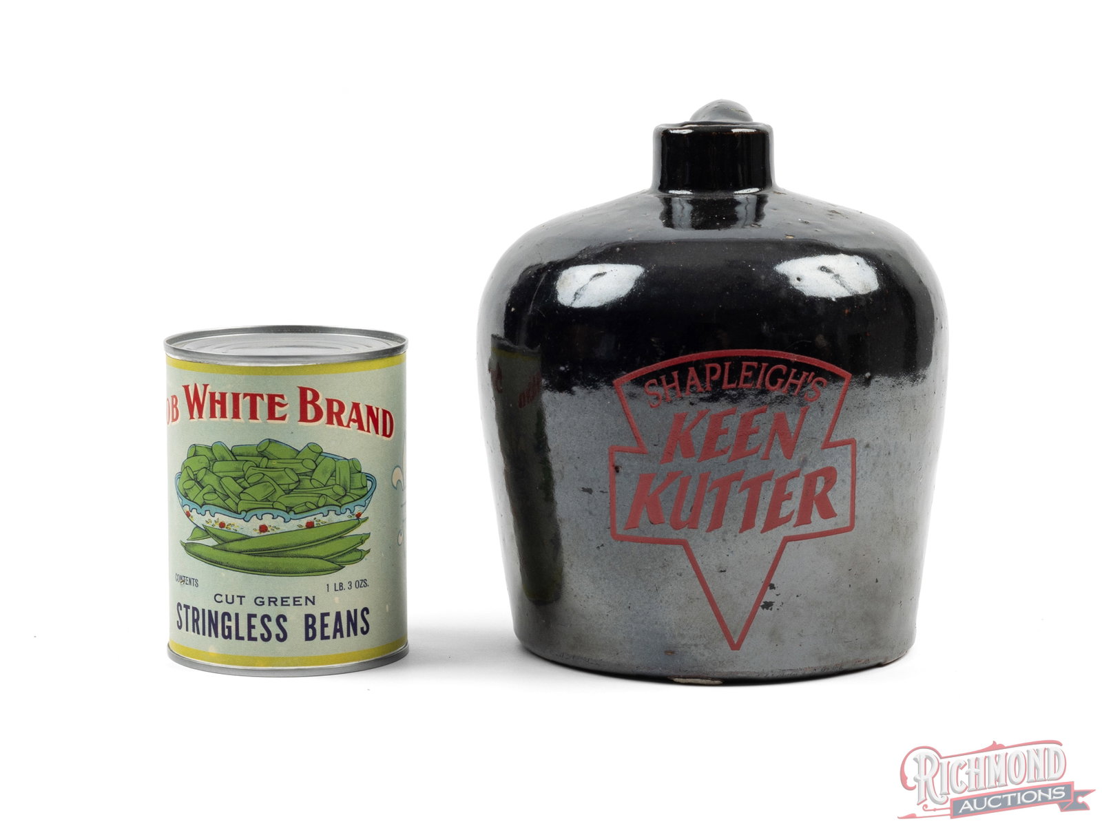 Shapleigh's Keen Kutter Stoneware Pottery Whiskey Jug and Bob White Brand Green Beans Can: Great nostalgic advertising lot! Stoneware whiskey jug features a brown glaze with red letter advertising "SHAPLEIGH'S KEEN KUTTER". Measures 8" tall and approximately 6" in diameter, about 1/2