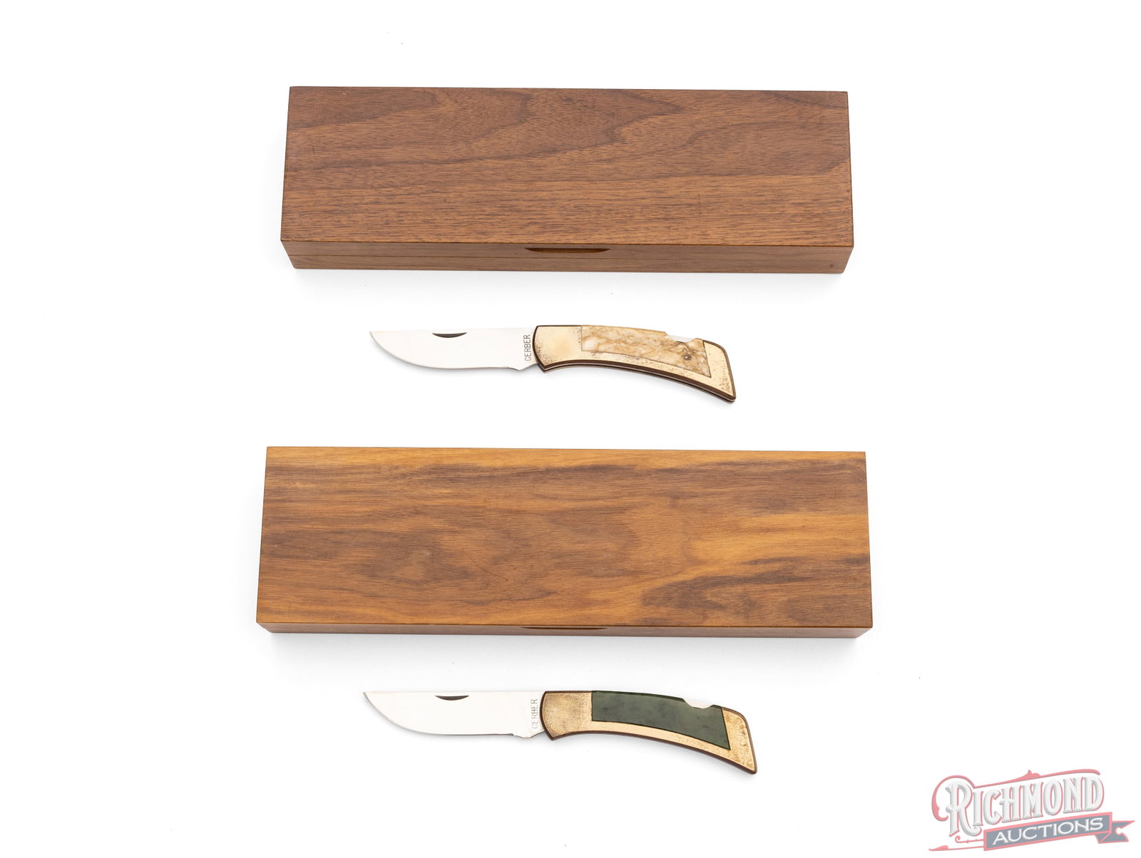 Two Gerber Legendary 97223 Lockback Folder Knives in Original Wood Cases: Two Gerber Legendary lockback folder knives, model 97223. Each folder knife features a 4" blade, brass housing and natural stone insert handles. Each come in the original walnut display cases.