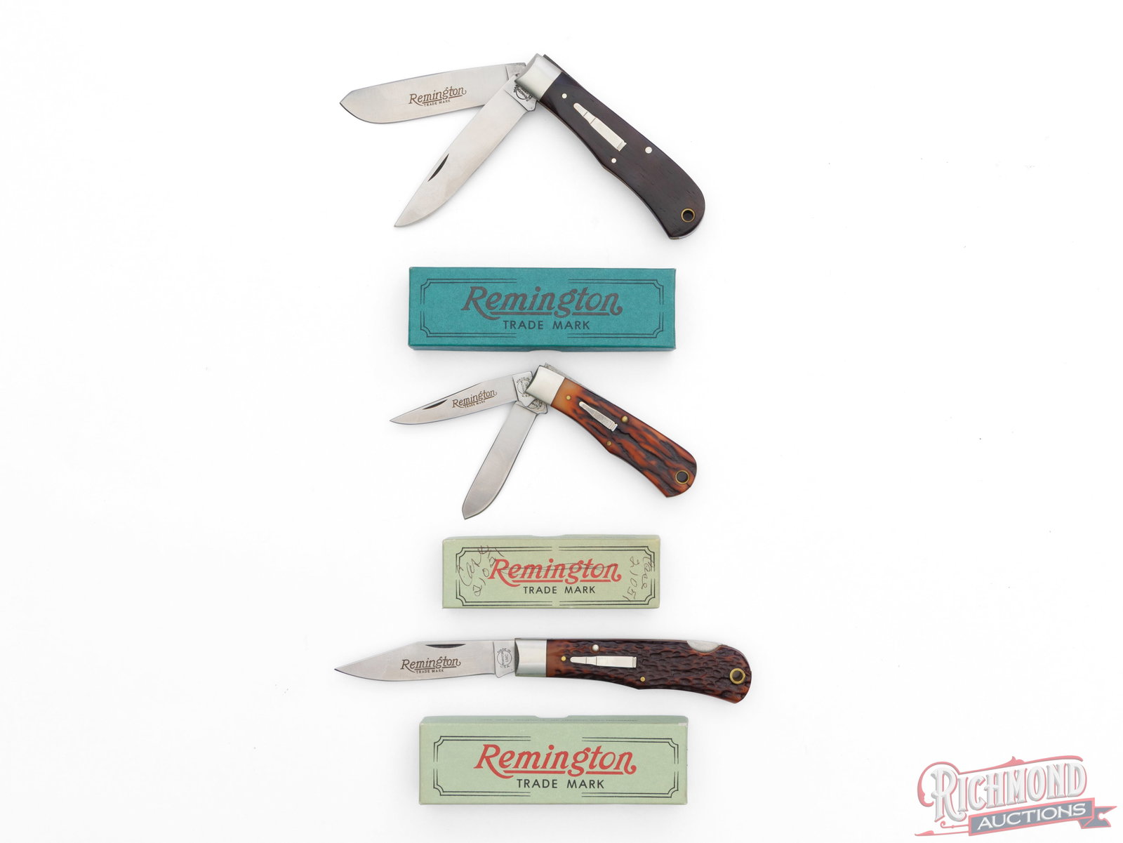 Three Collector Remington UMC "Bullet Knives" Folder Knives in Factory Boxes: This lot includes three Remington UMC bullet folder knives. All feature 440 stainless steel blades, brass liners and lanyard hole, nickel bolsters, and the famous nickel silver inlaid bullet. One
