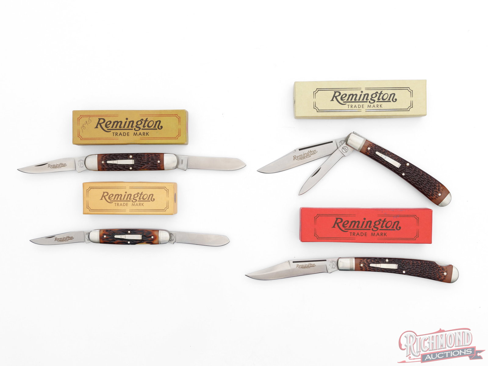 Four Collector Remington UMC "Bullet Knives" Folder Knives in Factory Boxes: All four knives come in factory boxes with original paperwork. All feature 440 stainless steel blades, brass liners, nickel bolsters, and jigged Delrin handles with the famous nickel silver inlaid