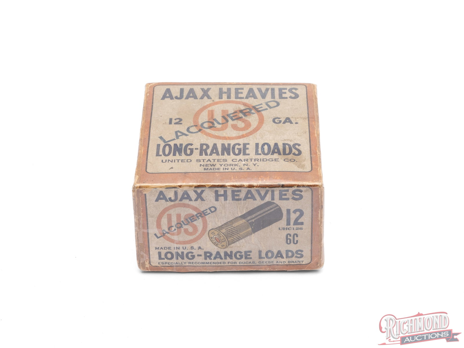 US Cartridge Co. 12 Gauge Ajax Heavies Lacquered Long Range Loads Collector's Box: This is an empty box of 12 gauge Ajax Heavies Long-Range Load shells made by US Cartridge Co. This two piece box has "Lacquered" across the "US" logo. The front panel has the additional call out