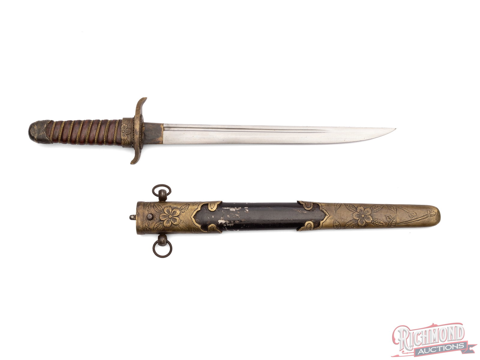 WWII Era Manchurian officer's Dagger With Crossed Flags Motif: This officer's dagger features a 9" single sided blade and measures 14" overall. It come in a button lock scabbard and features the cherry blossom on the scabbard and handguard. The base of the blade