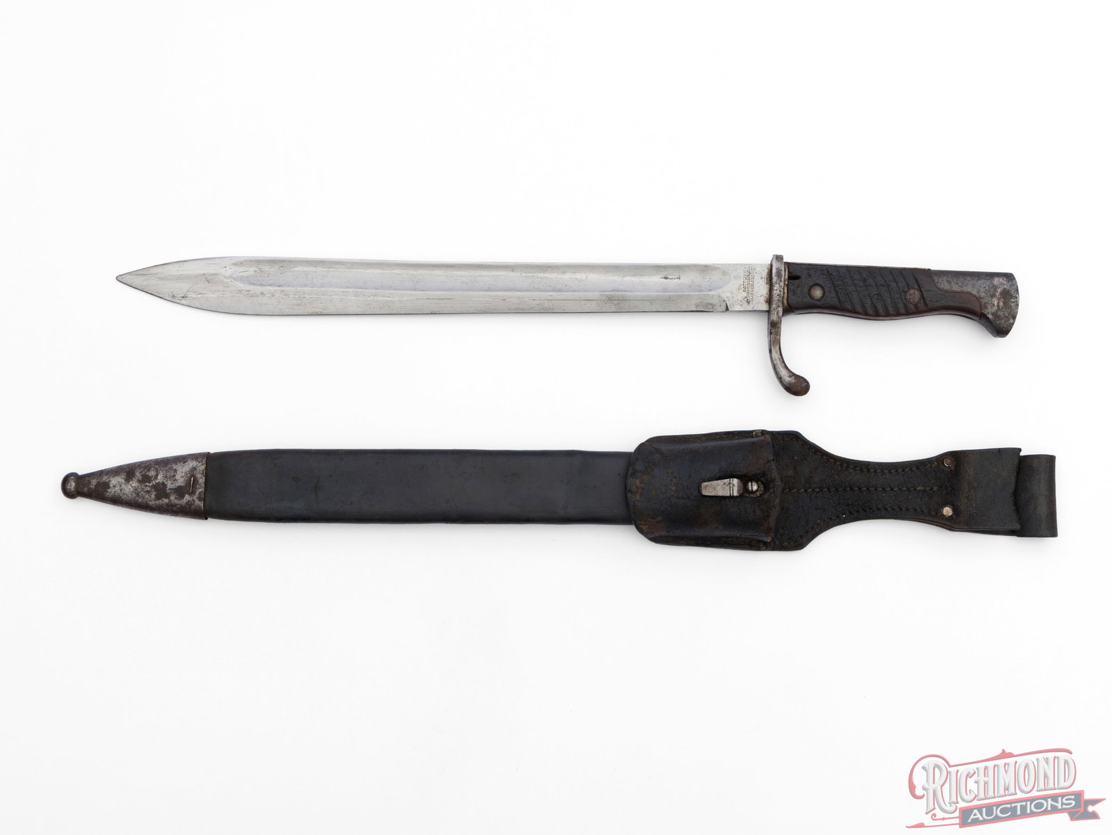 WW1 Era Gottlieb Hammesfahr Model 98/05 "Butcher Blade" Bayonet With Scabbard: This bayonet was made in Germany and fits to the Gewehr Model 1898 rifle. The bayonet has a 14 1/2" blade and measures 19 3/4" overall. It features a wooden grip and metal pommel with push button