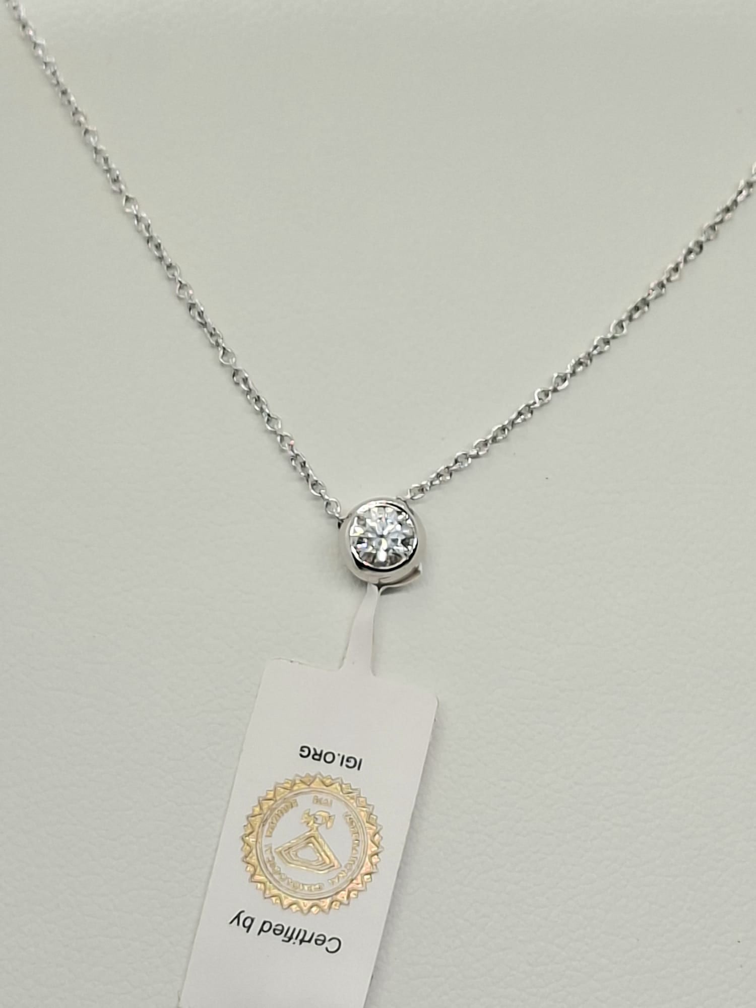 0.20 Ct Round Brilliant Natural Diamond Solitaire Pendant - 18K White Gold - IGI Certified: 0.20 Carat D-E VS-SI Round Brilliant Diamond Solitaire Pendant (18K White Gold) Official IGI Certified • 18K White Gold (Stamped 750) • Classic Bezel Solitaire • Colorless Diamond