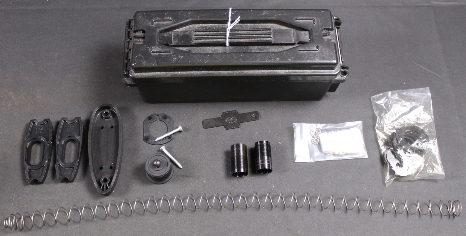 Group Lot: Shotgun Parts (LOL): This group lot of shotgun affiliated parts are all in like new condition and includes the following: (1) Magazine tube spring (2) Suspected 12 Ga chokes (Full) (Imp. Cyl.) and the removal tool (1)