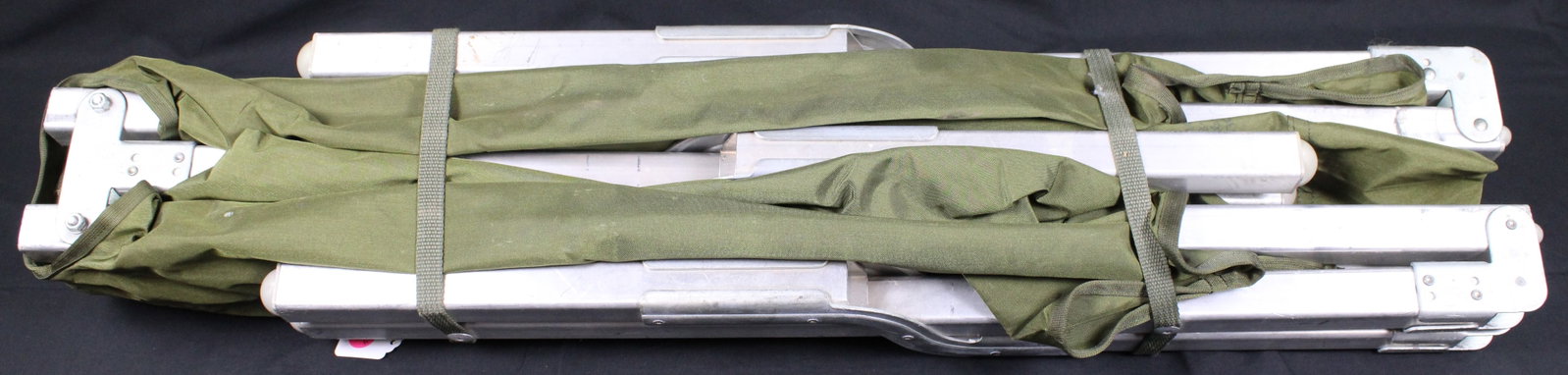 Vietnam Era USGI Aluminum U.S. Cot (PMC): This peice is a portable aluminum frame and a fabric sleeping surface. It’s commonly used for camping, military use, emergency shelters, or as a temporary guest bed. Bidders are welcome to