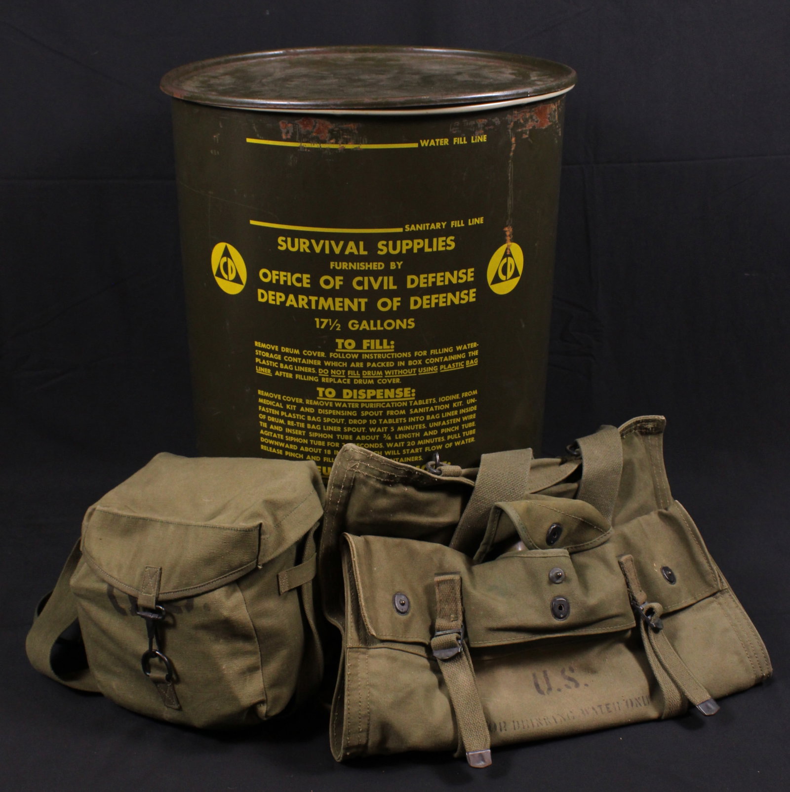 Group Lot: Cold War Civil Defense 17.5 Gallon Water Drum and Purifiaction Accessories (MAT): Description coming soon Bidders are welcome to preview items in person during our normal operating hours Tuesday through Saturday 11am-6pm. Estimated shipping parcel size (LxWxH) 24 inches x 18