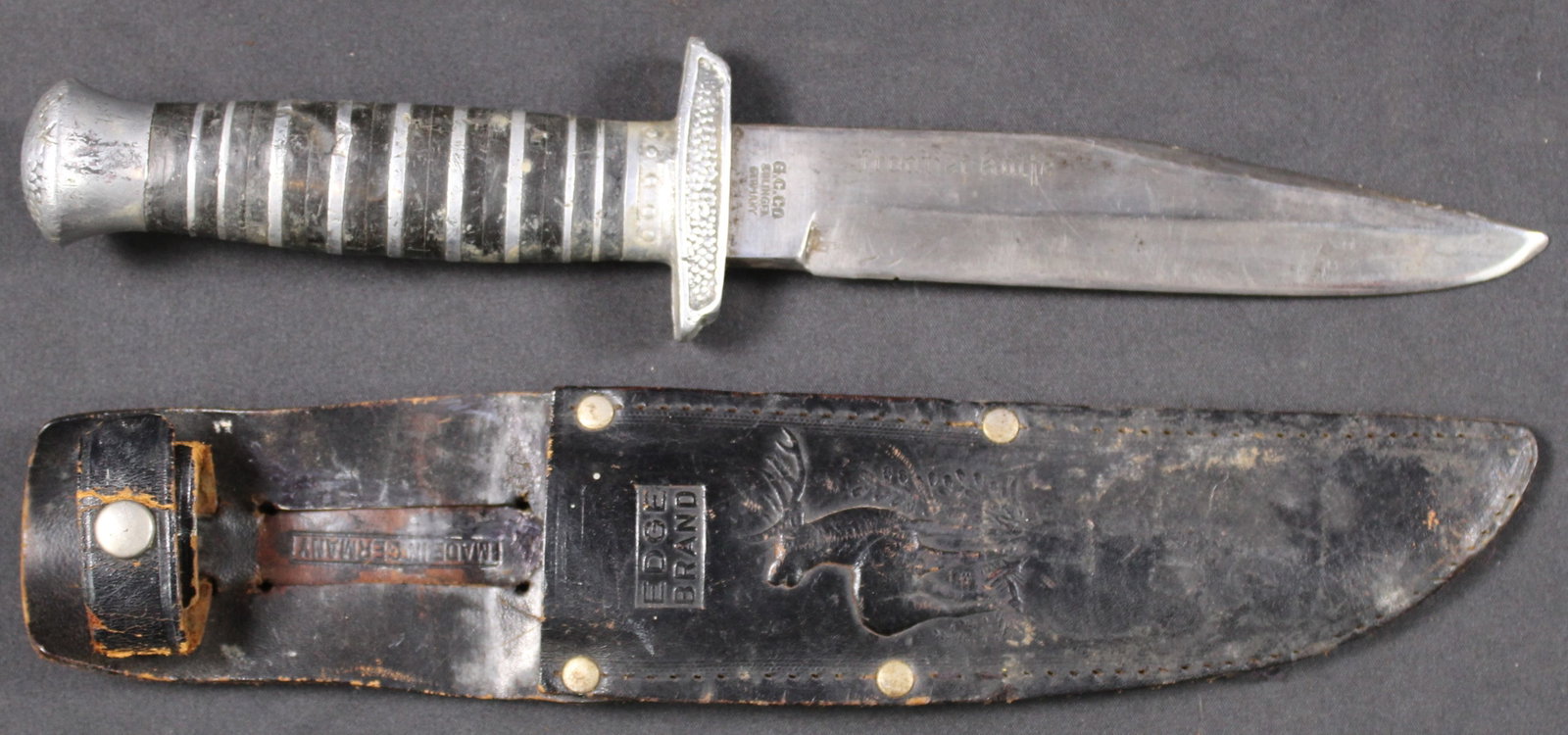 G.C. Co Solingen Fixed-Blade "Frontier Knife" and Sheath (SNR): A Solingen, Germany manufactured fixed-blade knife and sheath embossed "frontier knife" along the right side of the blade and "G.C.CO Solingen Germany" near the ricasso. SN 433. The sheath is pressed 