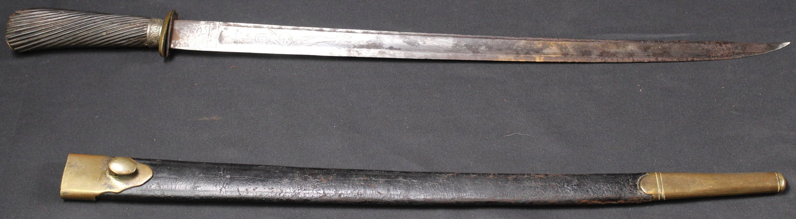 Large Fixed-Blade Hand Engraved Dagger (SNR): A large vintage hand engraved dagger in good condition overall. The blade measures approximately 16 inches and the total length is approximately 20 inches. The blade has some spots with darker patina