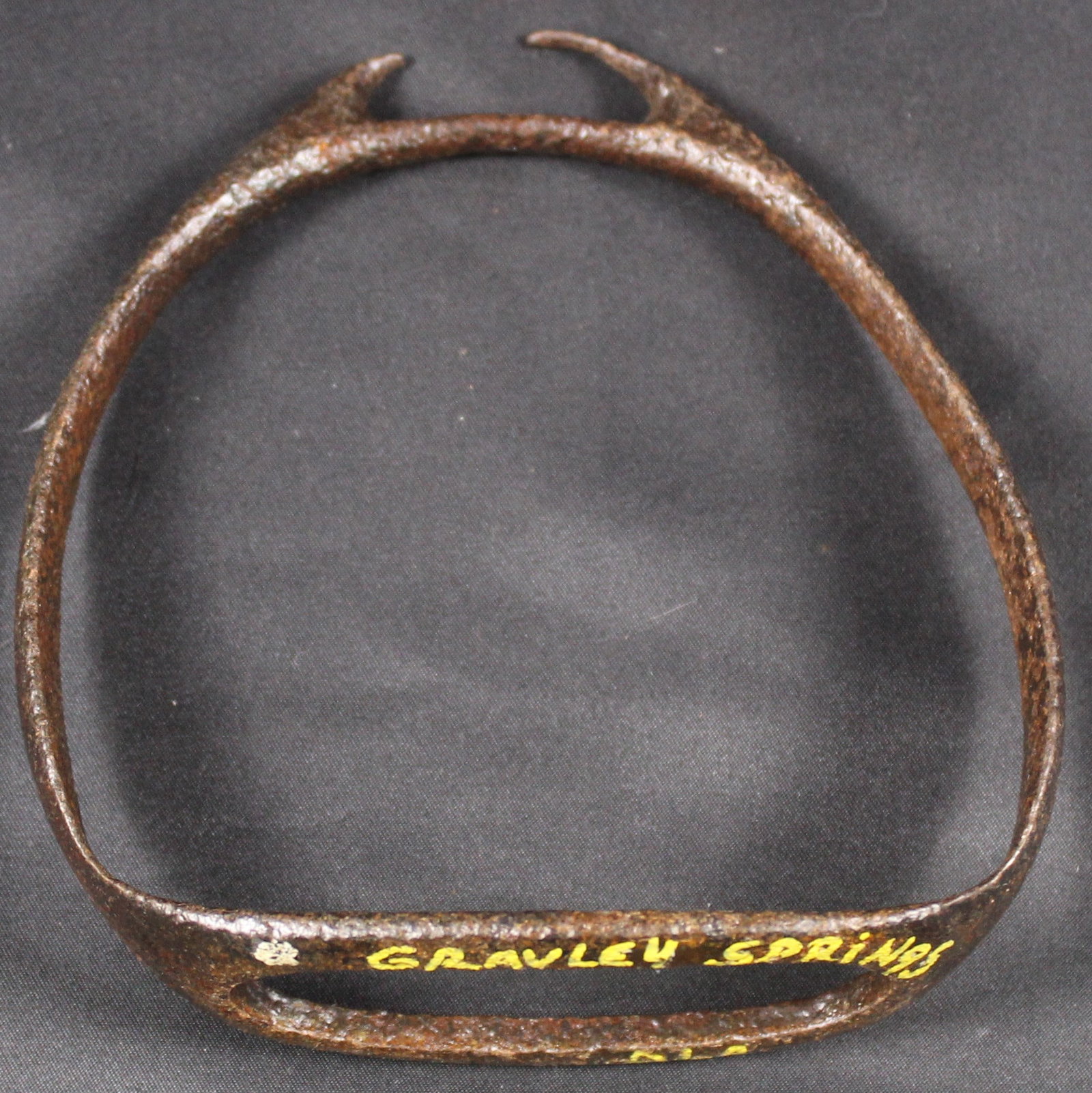 Cast Iron Stirrup c.1750-1780s Gravelly Springs, AL (SNR): A cast iron stirrup that was excavated from Gravelly Springs, Alabama dated to estimated 1750-1780s in good condition overall as a relic. The sides are ornate with embossments. Designed to
