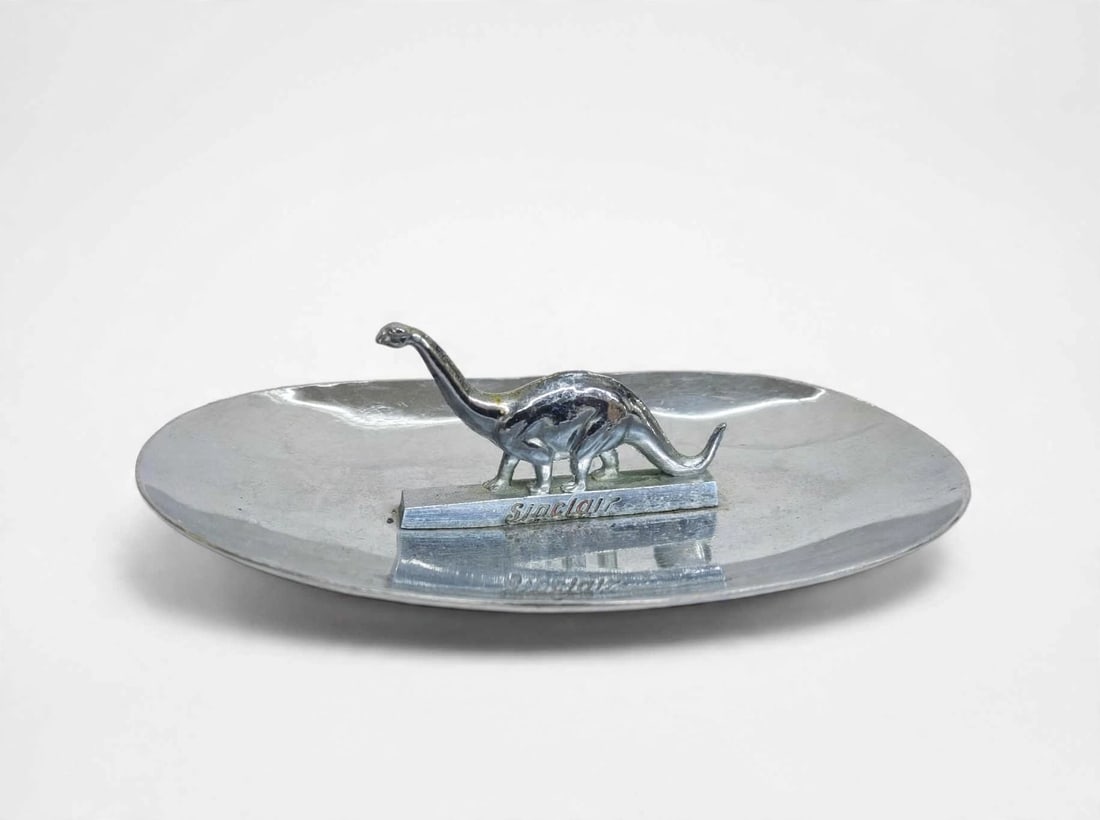 Vintage Sinclair Advertising Dino Chrome Ashtray: Vintage Sinclair Gas & Oil Station Advertising Dino Chrome Ashtray / Trinket Dish. It measures approximately 7.25” x 4.5” x 2.25”.