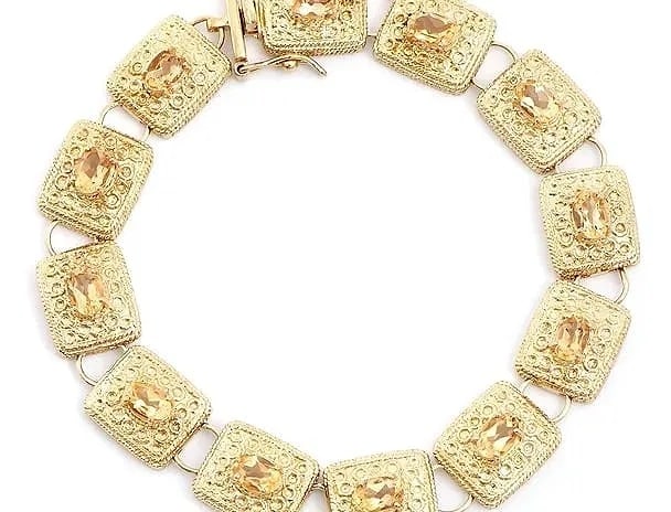 5.05 Ct Citrine 18K Gold Plated Bracelet Antique Style: An antique-inspired bracelet with a rich, warm citrine palette, substantial in feel and striking on the wrist. Details: Total Gem Weight: 5.05 ctw Citrine: 12 orange oval stones, 6x4mm, 5.05 ctw