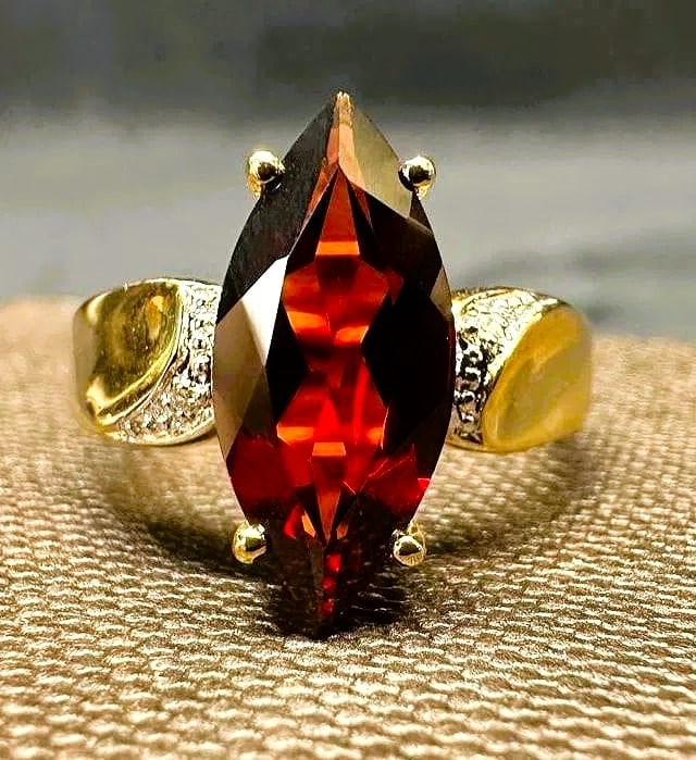 14K Gold 2.7 Ct. Marquise Garnet Cocktail Ring: A dramatic silhouette in deep crimson fire. This 14K yellow gold cocktail ring centers a richly saturated marquise-cut garnet weighing approximately 2.7 carats. The elongated navette form enhances the