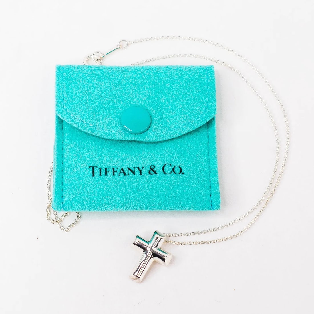 Tiffany & Co. Cross Necklace in Sterling Silver with Heart Edges 16" w/ Pouch: Tiffany & Co. Cross Necklace in Sterling Silver with Heart Edges - 16" Offered is a classic Tiffany & Co. sterling silver cross necklace featuring a clean, modern cross pendant with heart edges, on a
