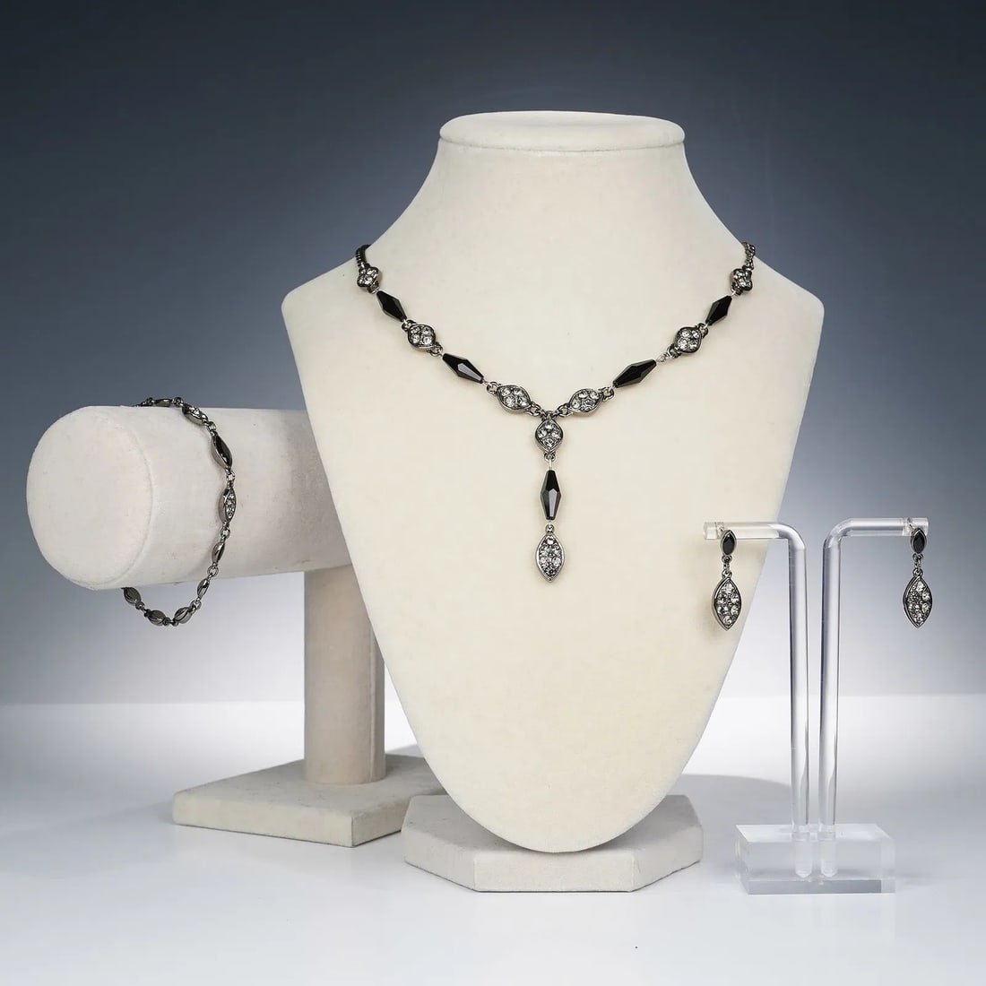 Swarovski 4pc Crystal Necklace/Bracelet/Earrings: Stylish four-piece Swarovski crystal jewelry suite including a coordinated necklace, bracelet, and earrings. Each piece features marquise-shaped links accented with clear Swarovski crystals and facete