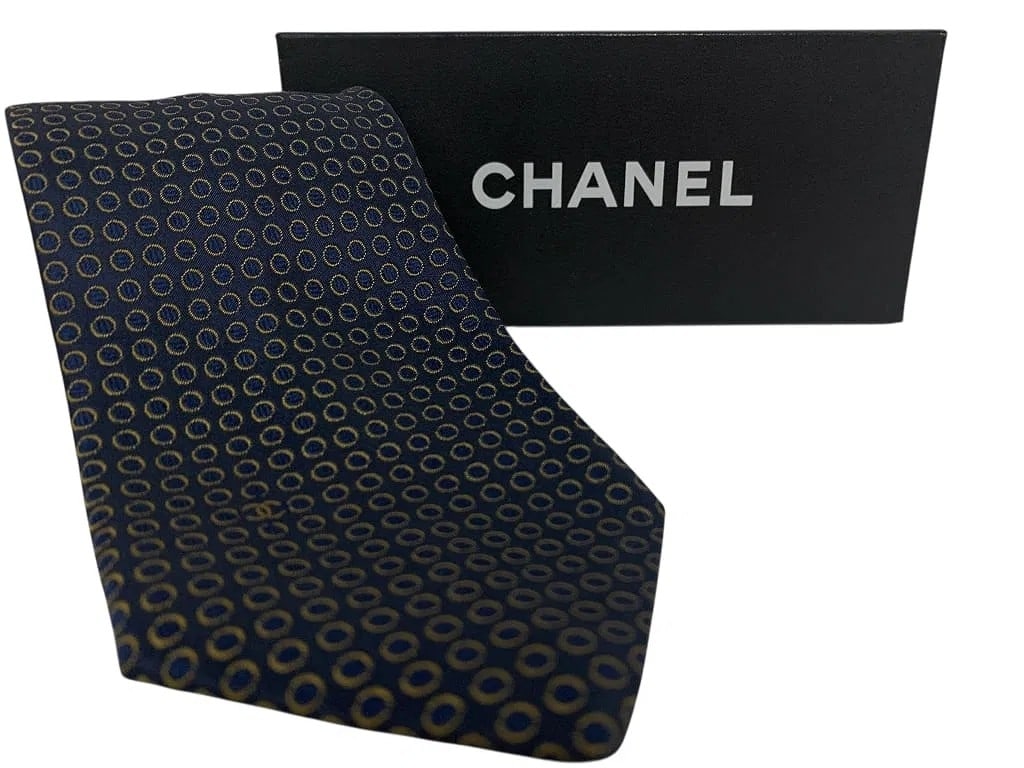 CHANEL Silk Necktie w/ Refined Navy Ground & Repeating Gold Circular Motif Like New + Box: Authentic CHANEL men's silk necktie with a refined navy ground and repeating gold circular motif. Subtle woven CC monogram integrated into the design for understated branding. A classic, elegant choic