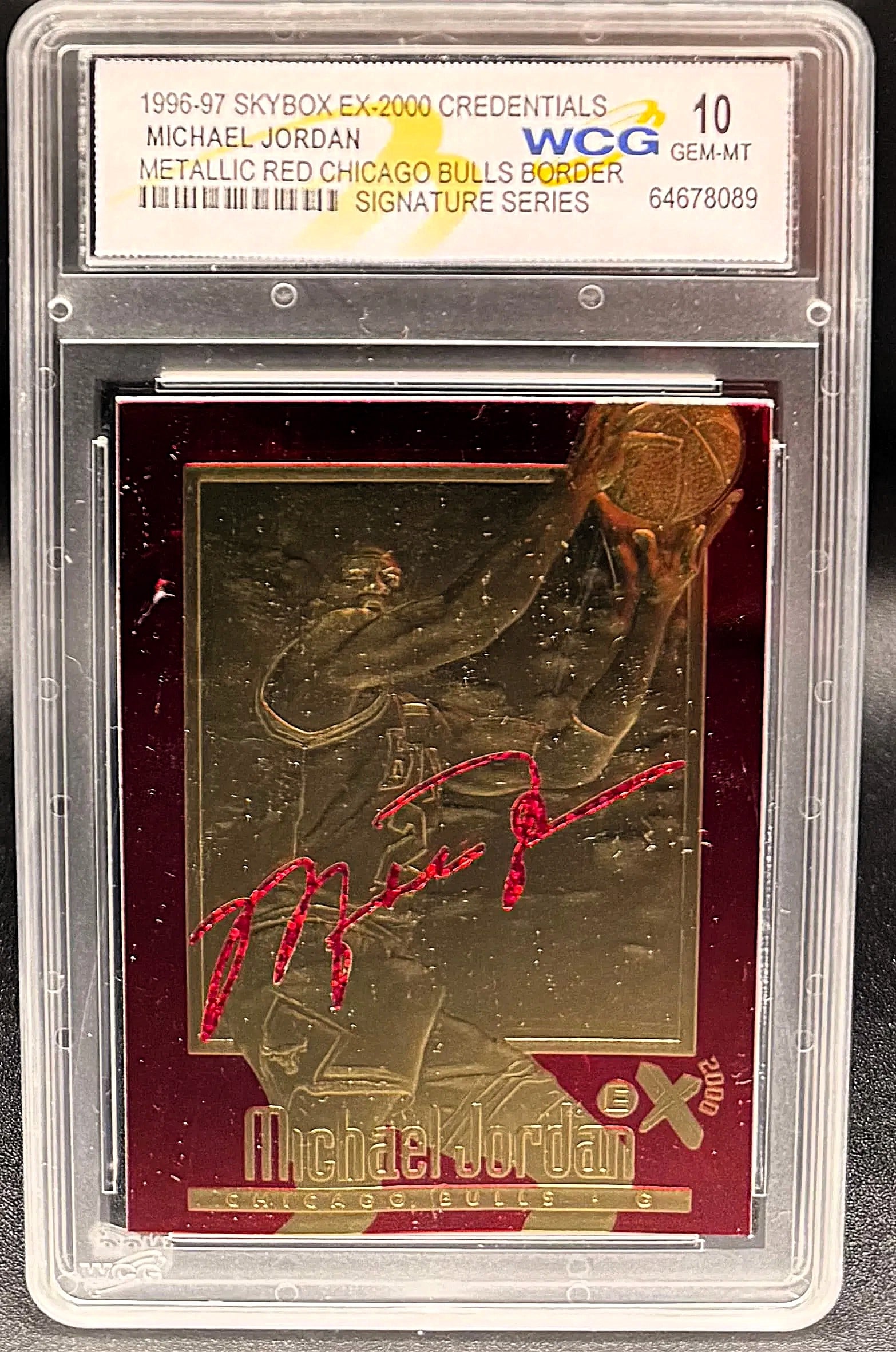 1998 Fleer 23KT Gold Michael Jordan Red Metallic – WCG GEM MT 10 – Signature Series: An exceptional sports collectible: a pristine WCG GEM MINT 10 example of Michael Jordan's 1998 Fleer 23KT Gold Red Metallic Signature Series. The composition features a striking, deep red metallic bor