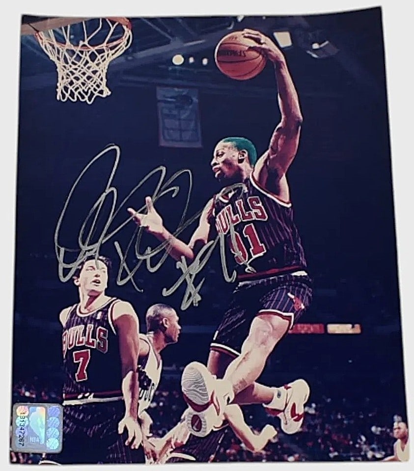 Dennis Rodman w/ Green Hair Autographed Chicago Bulls 8"x10" Photo w/ COA: Dynamic action 8" x 10" photo of Dennis Rodman during his Chicago Bulls era, signed prominently and accompanied by a Certificate of Authenticity. Highlights: Signed 8x10 Dennis Rodman photo "Green hai