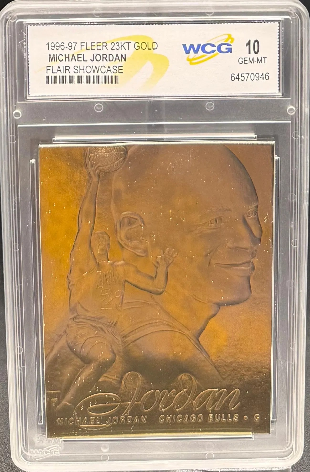 1996 Fleer Flair Showcase Michael Jordan 23KT Gold – WCG GEM MT 10 – Rare Commemorative: An exceptional sports collectible: a pristine WCG GEM MINT 10 example of Michael Jordan's 1996-97 Fleer Flair Showcase 23KT Gold commemorative. The composition features a sophisticated dual-image desi