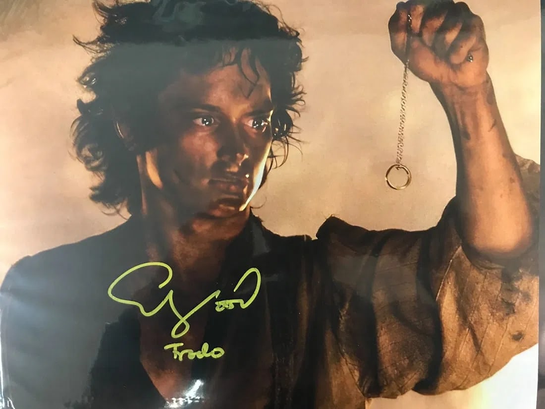 Elijah Wood Signed and Inscribed The Lord of the Rings Photo 8"x10" WWOC COA: Elijah Wood signed and Inscribed The Lord of the Rings 8x10 photo. Signature appears on the photo (yellow ink). Accompanied by WWOC authentication. Highlights Elijah Wood autograph and inscription on