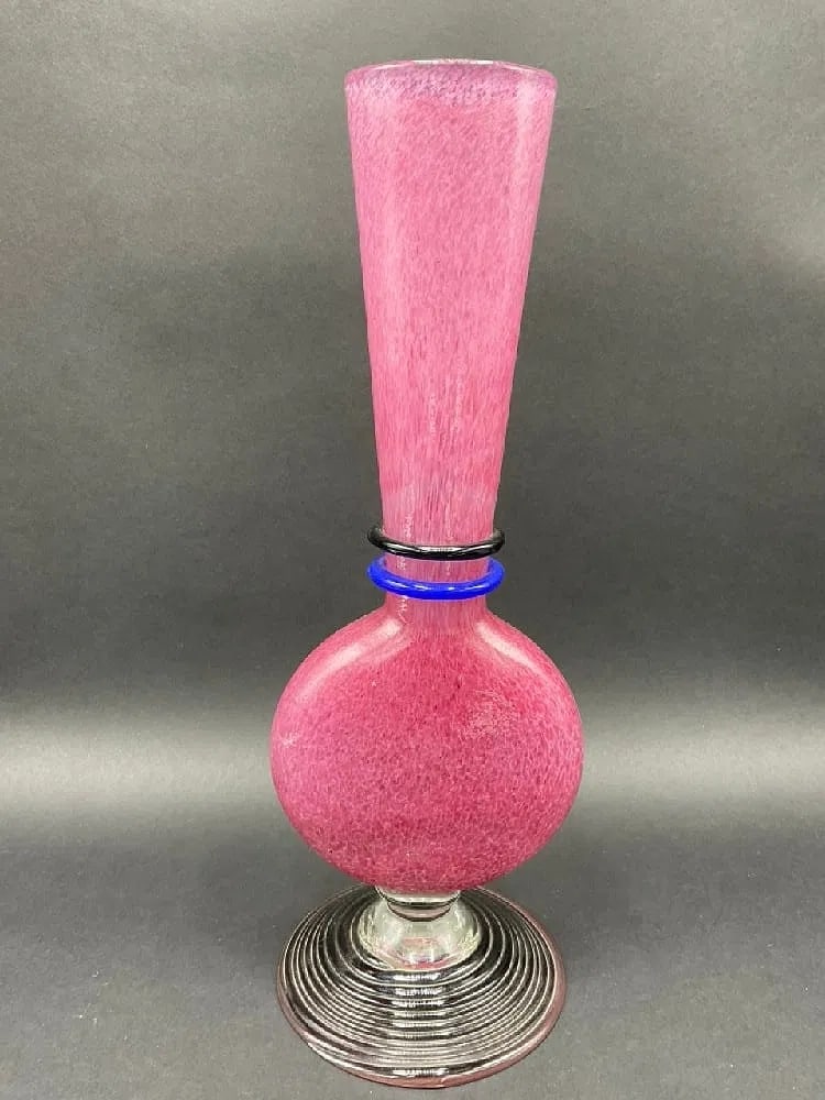 Kosta Boda Swedish Pink Blown Art Glass Sculpture – Signed – 12.5" Height x 4.5" Diameter: A refined expression of Scandinavian Modernism: this Kosta Boda blown glass vase features a textured "nebula" pink field with high-contrast cobalt and obsidian glass collars. The architectural silhoue