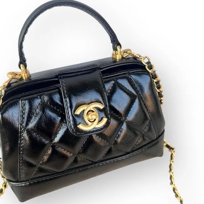 CHANEL Black Quilted 2-Way Doctor Beauté Bag – Gold Hardware – NIB: A masterclass in structured elegance: this CHANEL Beauté bag reimagines the classic "doctor" silhouette with contemporary Parisian flair. Rendered in a high-gloss black quilted finish, the bag is def