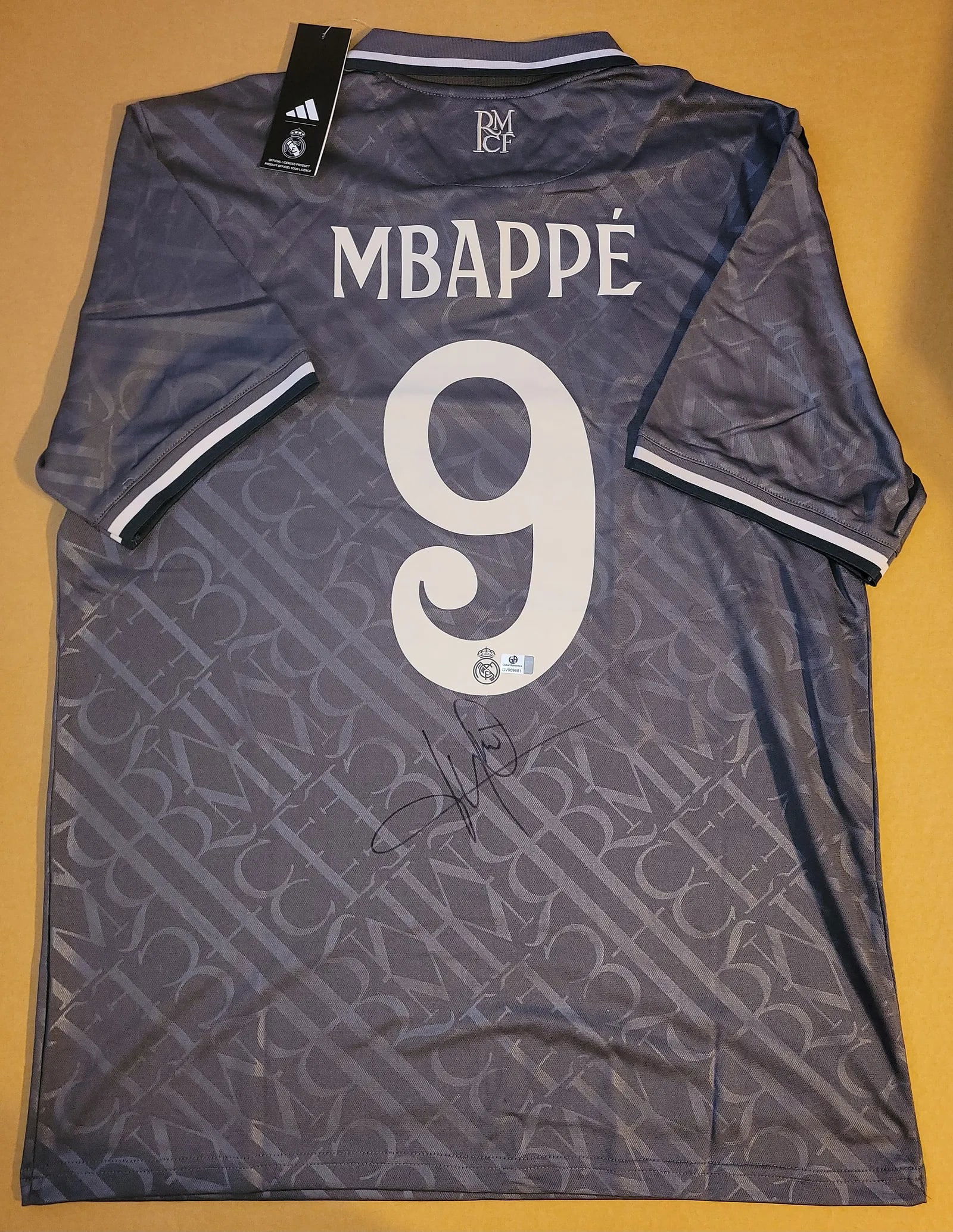 Kylian Mbappé Real Madrid Autographed 2024-25 Adidas Third Jersey – GA COA: An authentic Adidas 2024-25 Real Madrid Third Jersey signed by global football icon Kylian Mbappé. This Extra Large Adidas-manufactured jersey features the Real Madrid crest, Emirates sponsor, and Ae