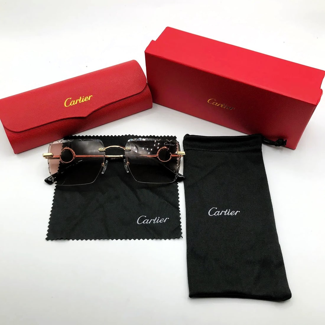 Cartier Rimless Shield Sunglasses w/ Red Case & Accessories: Rimless shield sunglasses marked Cartier, presented with red case and branded accessories as shown. The design features a single-piece gradient lens with circular C-motif temple hardware and gold-tone