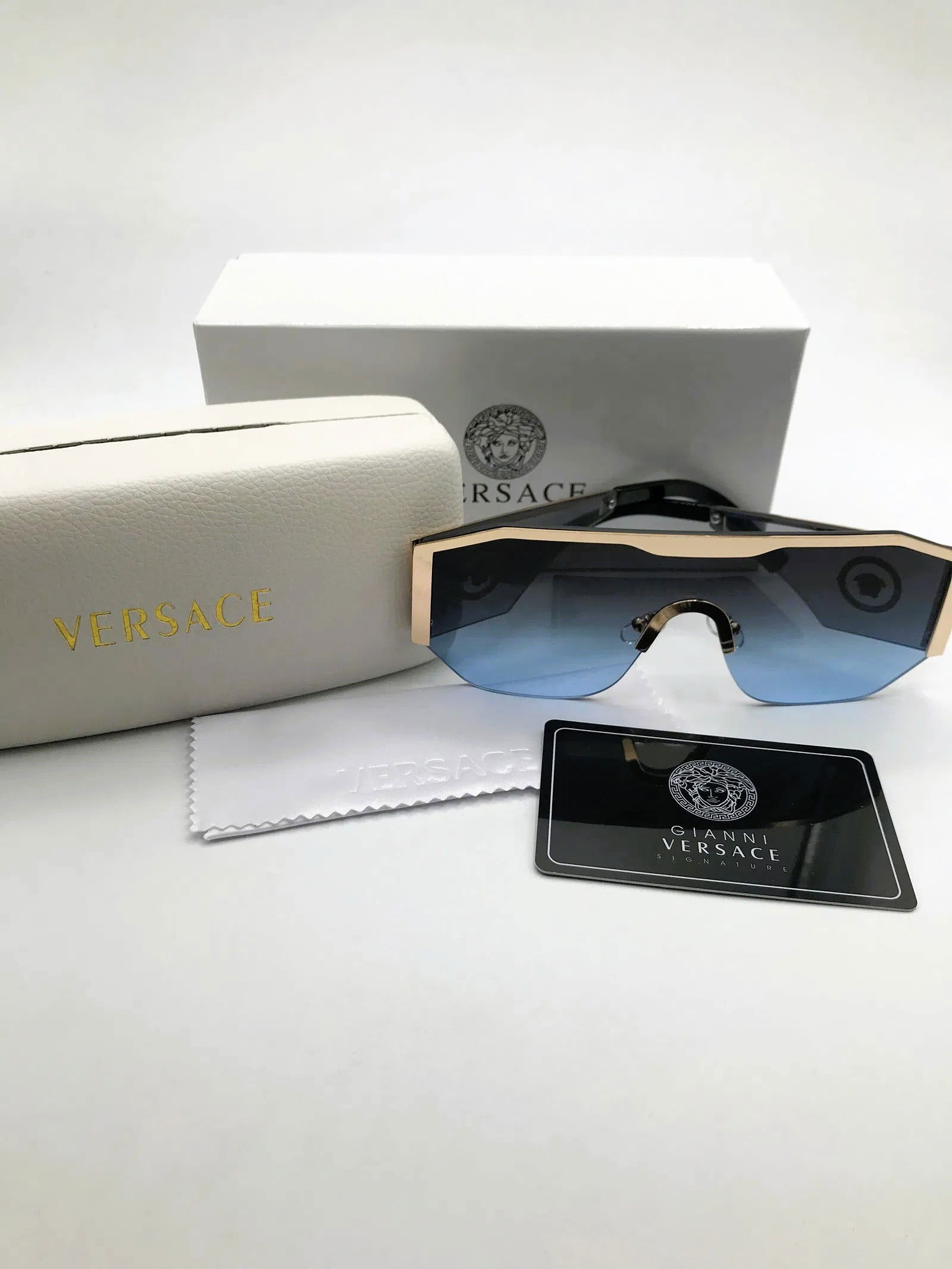 Versace Blue Gradient Shield Sunglasses w/ Case & Signature Card: Shield-style sunglasses marked Versace, presented with branded case and signature card as shown. This pair features a single-piece blue gradient lens with gold-tone brow bar and Medusa-style emblem