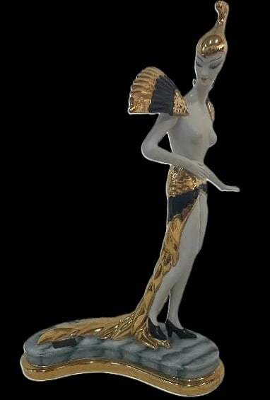Ester Bassano Limited Edition Art Deco Style Gilt Porcelain Lady 14" x 8" x 5": A dramatic masterclass in late-20th-century theatrical luxury: this Ester Bassano porcelain figure features an attenuated, Art Deco-inspired silhouette that captures the high-glamour essence of the 19