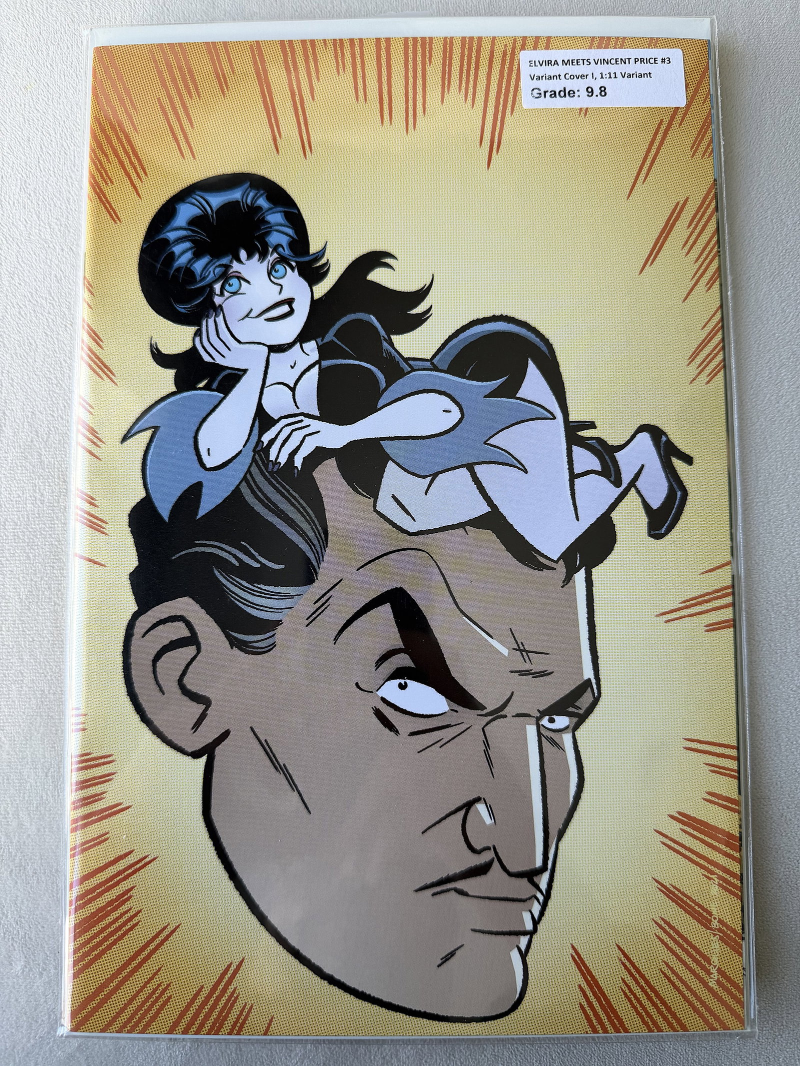 Elvira Meets Vincent Price #3 (2021) – 1:11 Retailer Incentive – Collector Grade 9.8: A standout specimen of modern horror history: Elvira Meets Vincent Price #3 (2021) featuring the rare 1:11 Retailer Incentive Variant. This issue brings together two undisputed titans of the macabre--