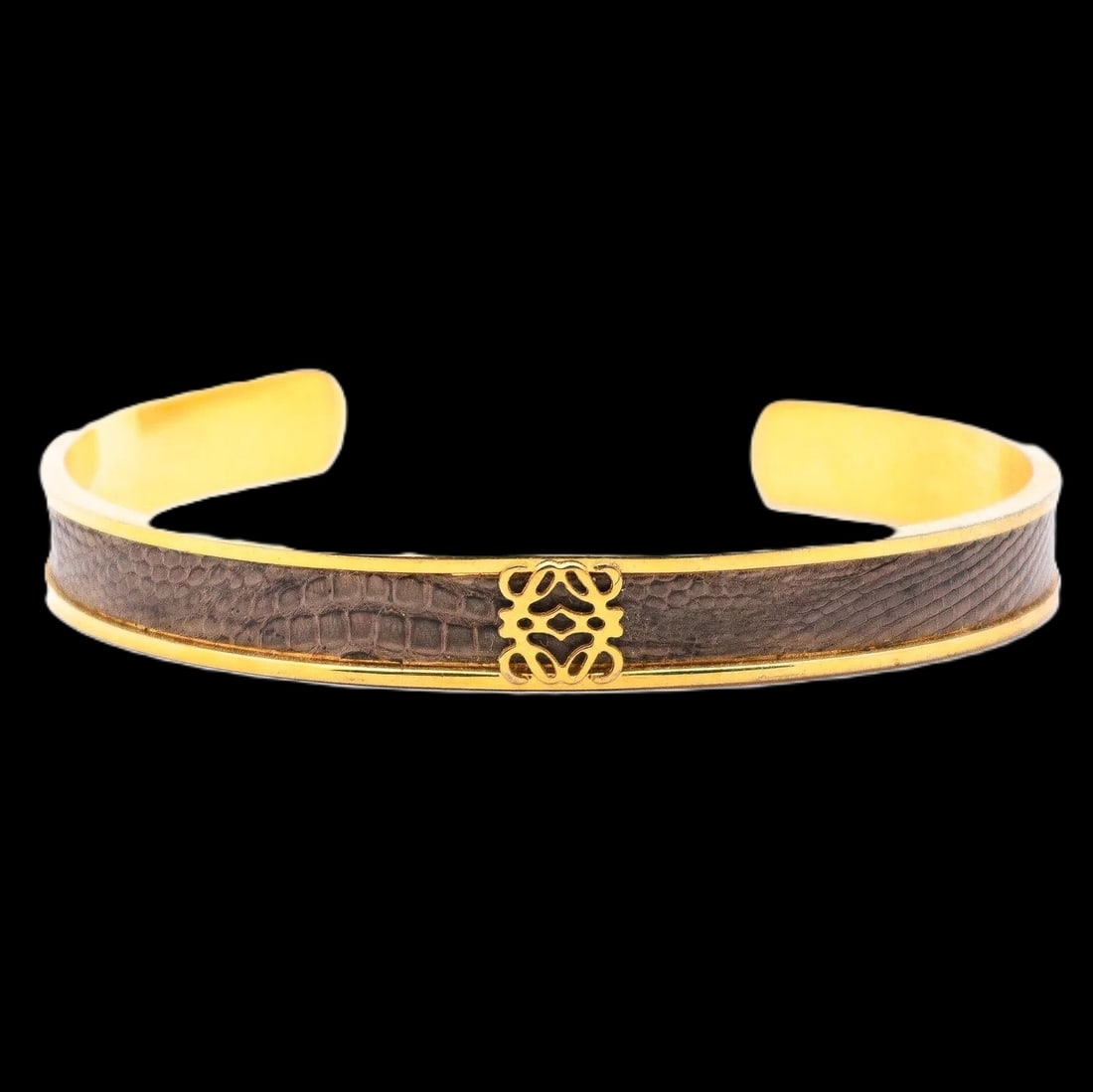 Loewe Logo Motif Gold-Tone & Enamel Cuff Bangle: Loewe open cuff bangle in gold tone with enamel detailing and a centered Loewe logo motif. Clean, modern branded look, easy to stack or wear solo. Comes with box. Highlights Marked LOEWE / Made in Spa