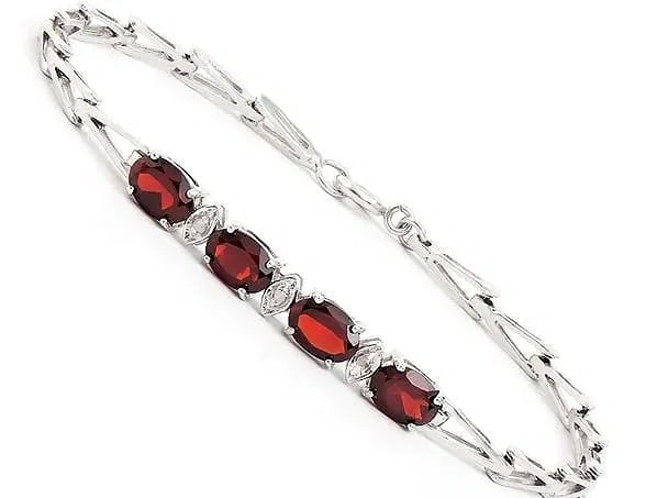 3.35 Ct Garnet Diamond Rhodium Bracelet: A sleek, modern bracelet featuring beautiful garnets and diamond accents, finished in bright rhodium plating for a crisp, high-end look. Details: Total Gem Weight: 3.35 ctw Garnet: 4 brown oval stones