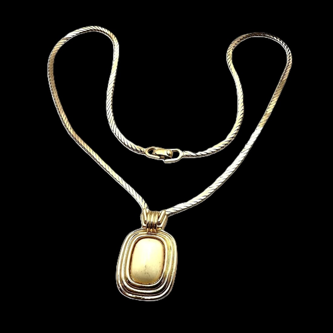 MSRP $995 Christian Dior Vintage Off-White Pendant Necklace and Gold-Tone Chain 16": Vintage Christian Dior Off-White Pendant Necklace Offered is a vintage Christian Dior necklace featuring an off-white pendant on a gold-tone chain. The contrast of the creamy pendant with warm metal g