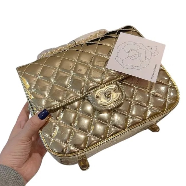 MSRP $5,500 CHANEL Metallic Gold Quilted Beauté Backpack & Matching Star Pouch NIB: A high-impact masterclass in gilded luxury: this CHANEL Beauté backpack is rendered in a radiant metallic gold finish with signature diamond quilting. The architectural, structured silhouette i