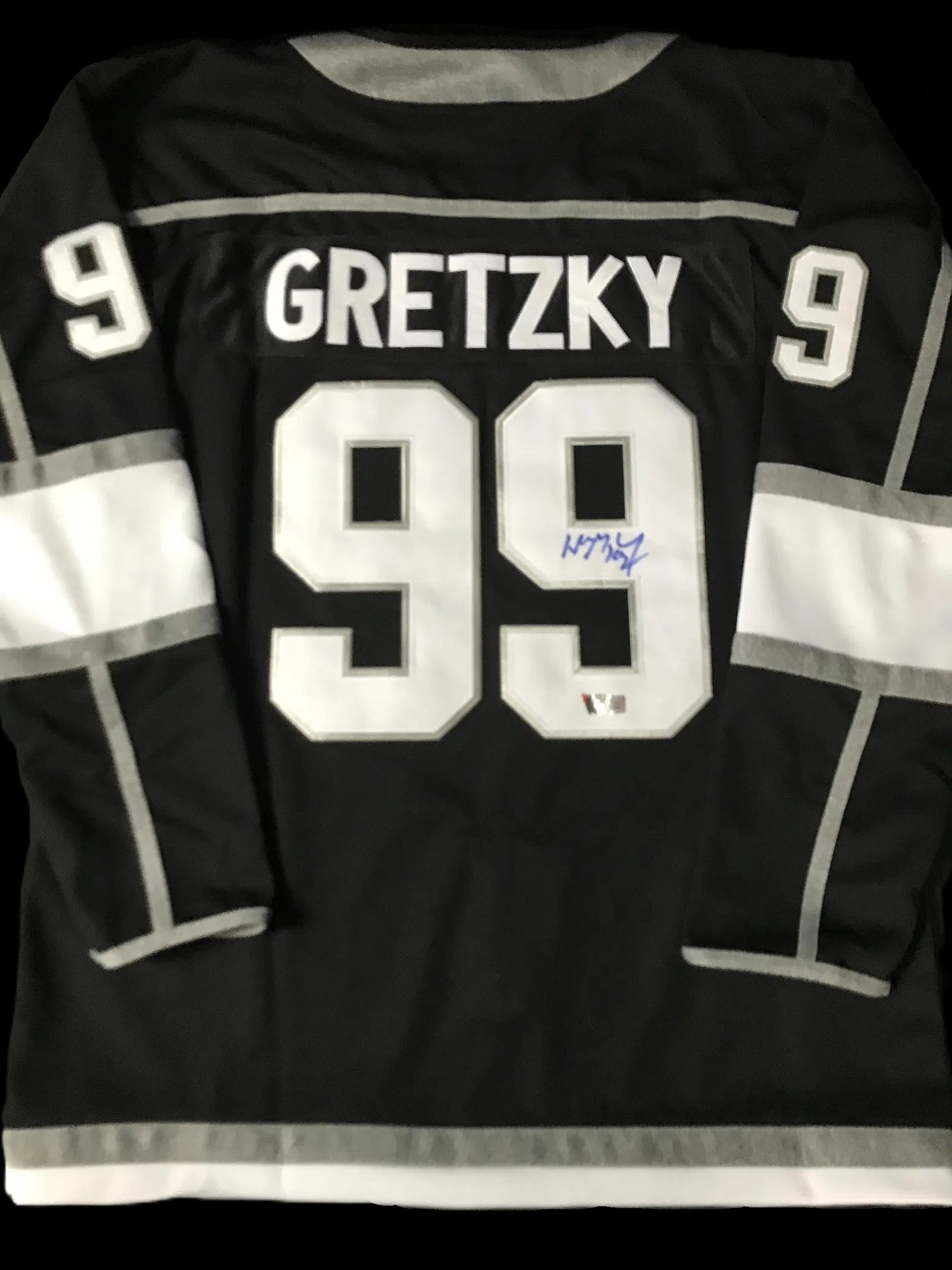 Wayne Gretzky Signed Los Angeles Kings Jersey – Captain "C" – ACE COA: A Los Angeles Kings black alternate–style jersey signed by hockey legend Wayne Gretzky, featuring the iconic number 99 and captain’s "C." The bold blue signature appears on the back numera