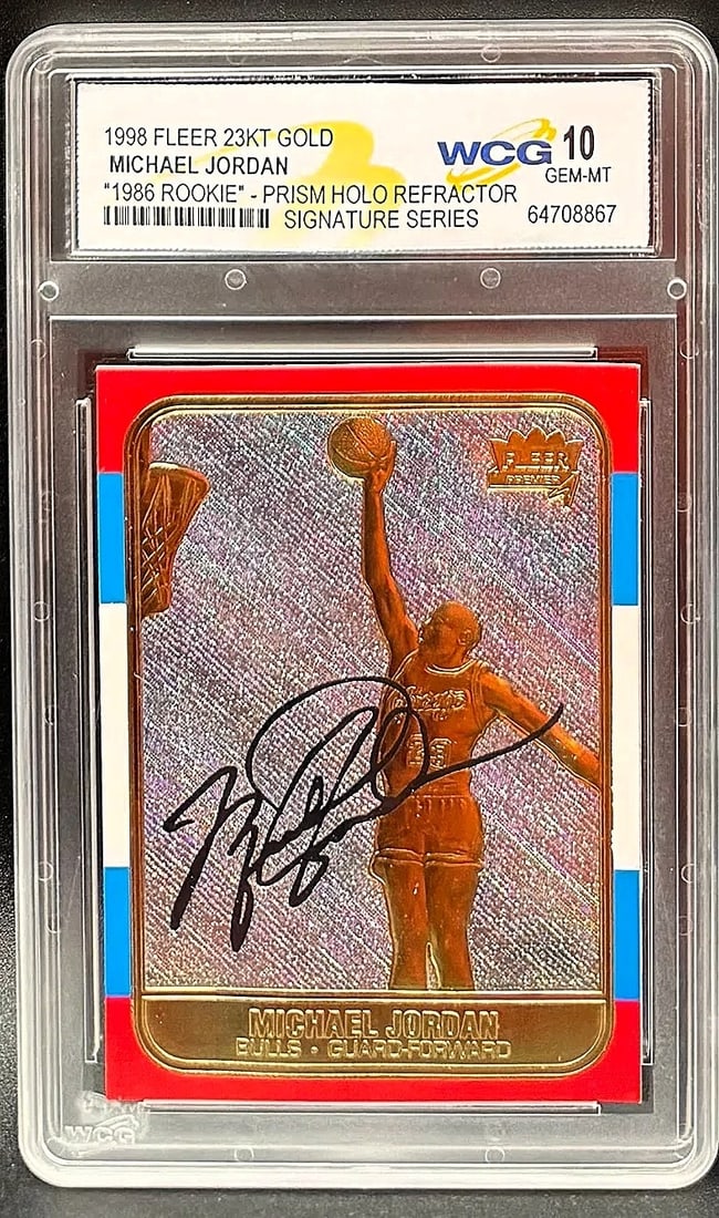1998 Fleer 23KT Gold Michael Jordan Prism Holo Refractor – WCG GEM–MT 10 –: An exceptional sports collectible: a pristine WCG GEM MINT 10 example of Michael Jordan’s 1998 Fleer 23KT Gold Prism Holo Refractor. The composition features a visually dynamic prismatic backgro