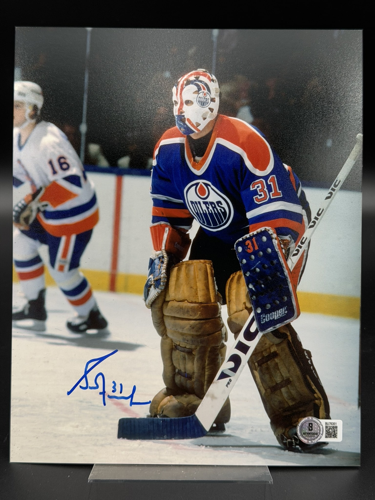 Autographed Grant Fuhr Edmonton Oilers 8" x 10" Photo Beckett COA: Color photograph personally signed by Hockey Hall of Fame goaltender Grant Fuhr in bold blue marker, adding his jersey number "31" beneath the signature. The image captures Fuhr in goal for the Edmont