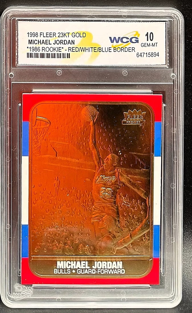 1998 Fleer 23KT Gold Michael Jordan Red/White/Blue Border – WCG GEM–MT 10 – Rare: An exceptional sports collectible: a pristine WCG GEM MINT 10 example of Michael Jordan’s 1998 Fleer 23KT Gold "1986 Rookie" Red/White/Blue Border. The composition features a patriotic tri&ndash