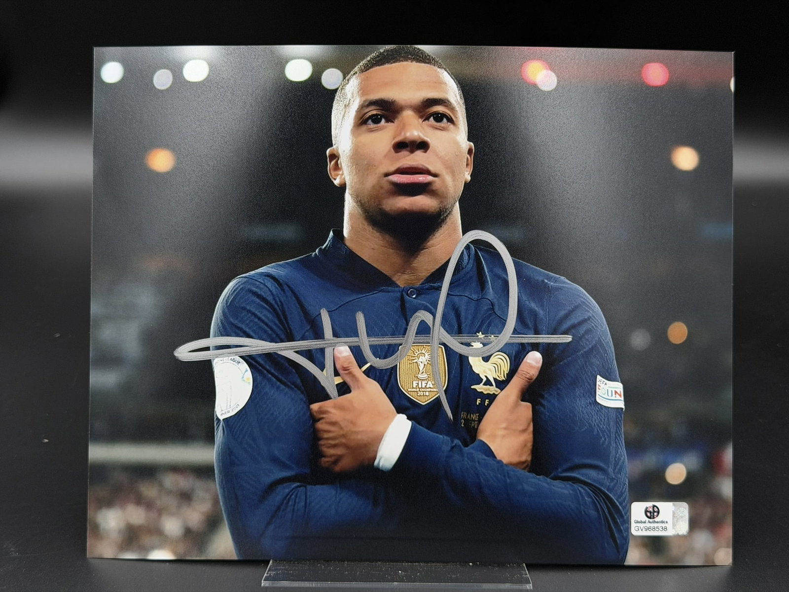 Kylian Mbappé Signed France National Team Photo GA COA 8" x 10": Official color photograph personally signed by Kylian Mbappé in silver marker across the front. The image captures Mbappé celebrating while wearing the France national team jersey featur