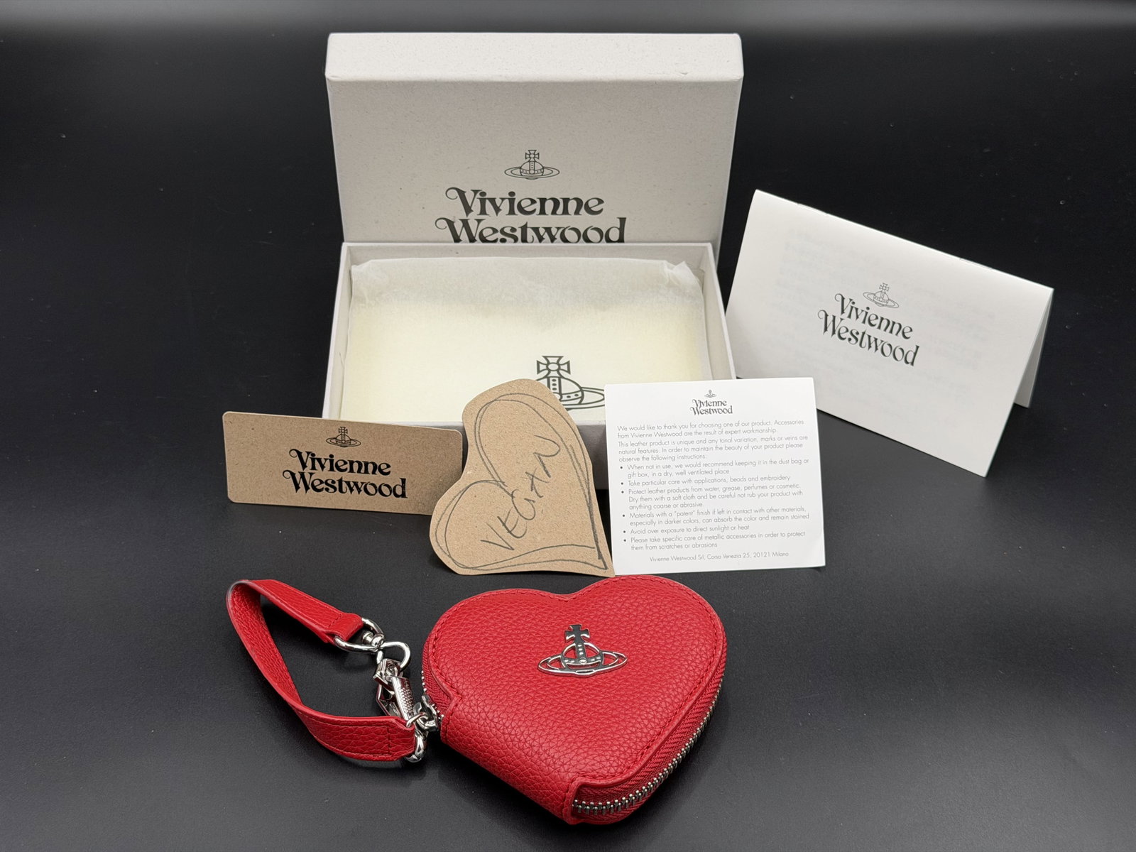 MSRP $525 Vivienne Westwood Johanna Heart Coin Case Red Faux Leather Wristlet w/ Box Tags: Vivienne Westwood Johanna Heart Coin Case Red Leather Keychain Wallet w/ Box Tags Vivienne Westwood Johanna Heart Coin Case crafted from textured red faux leather with the iconic silver-tone Orb emble